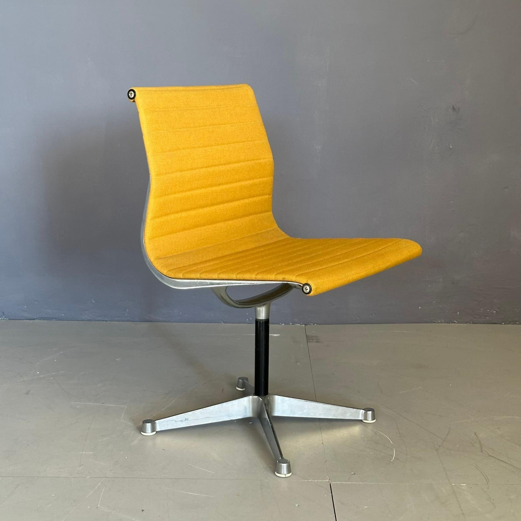 EA105 armchair design by Charles Eames for Herman Miller, 1960s, with swivel seat. Aluminum structure with four-legged base.
The serial number and Herman Miller production symbol are imprinted under the seat.
Original yellow fabric.