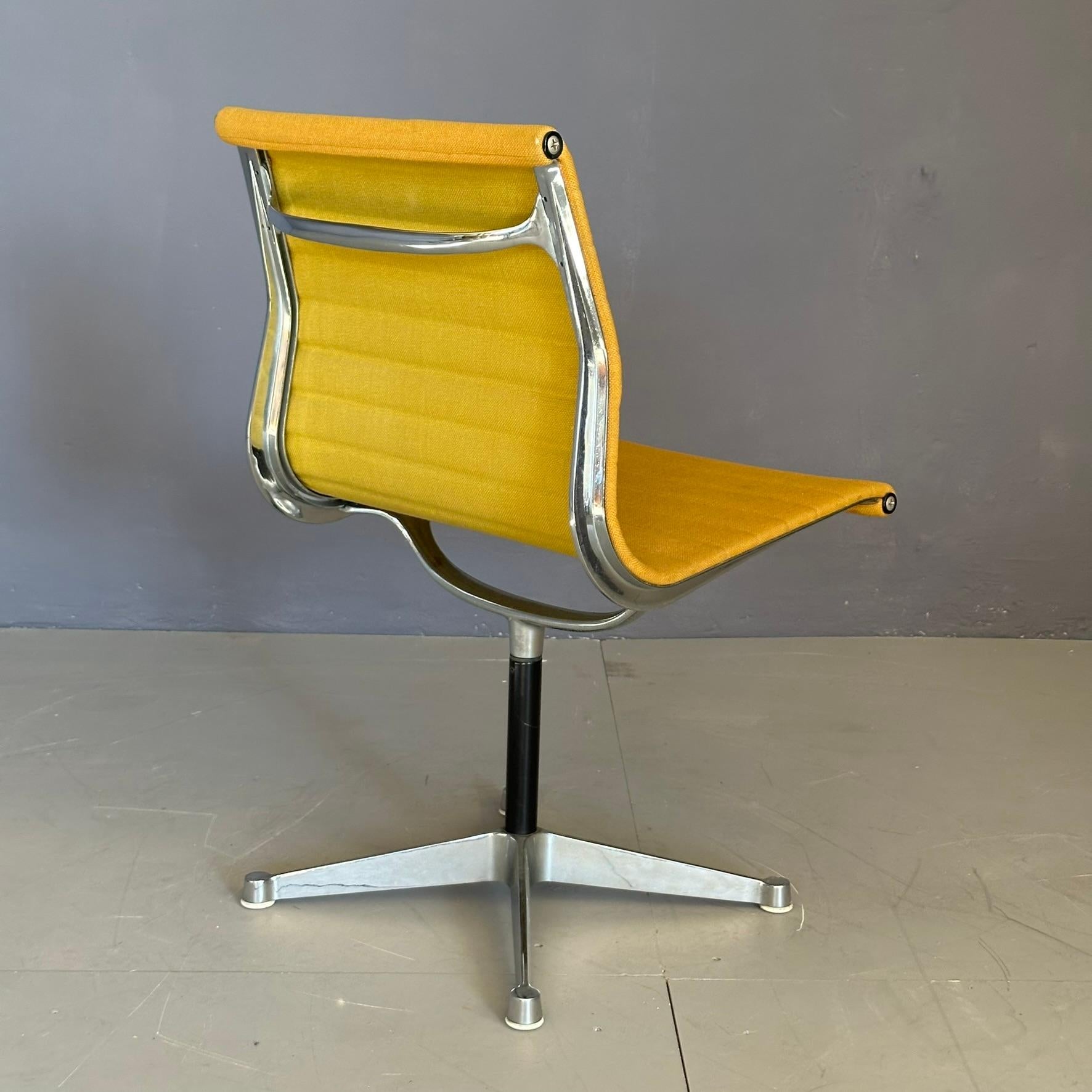 Mid-Century Modern EA105 yellow chair design by Charles Eames for Herman Miller, 1960s swivel seat For Sale