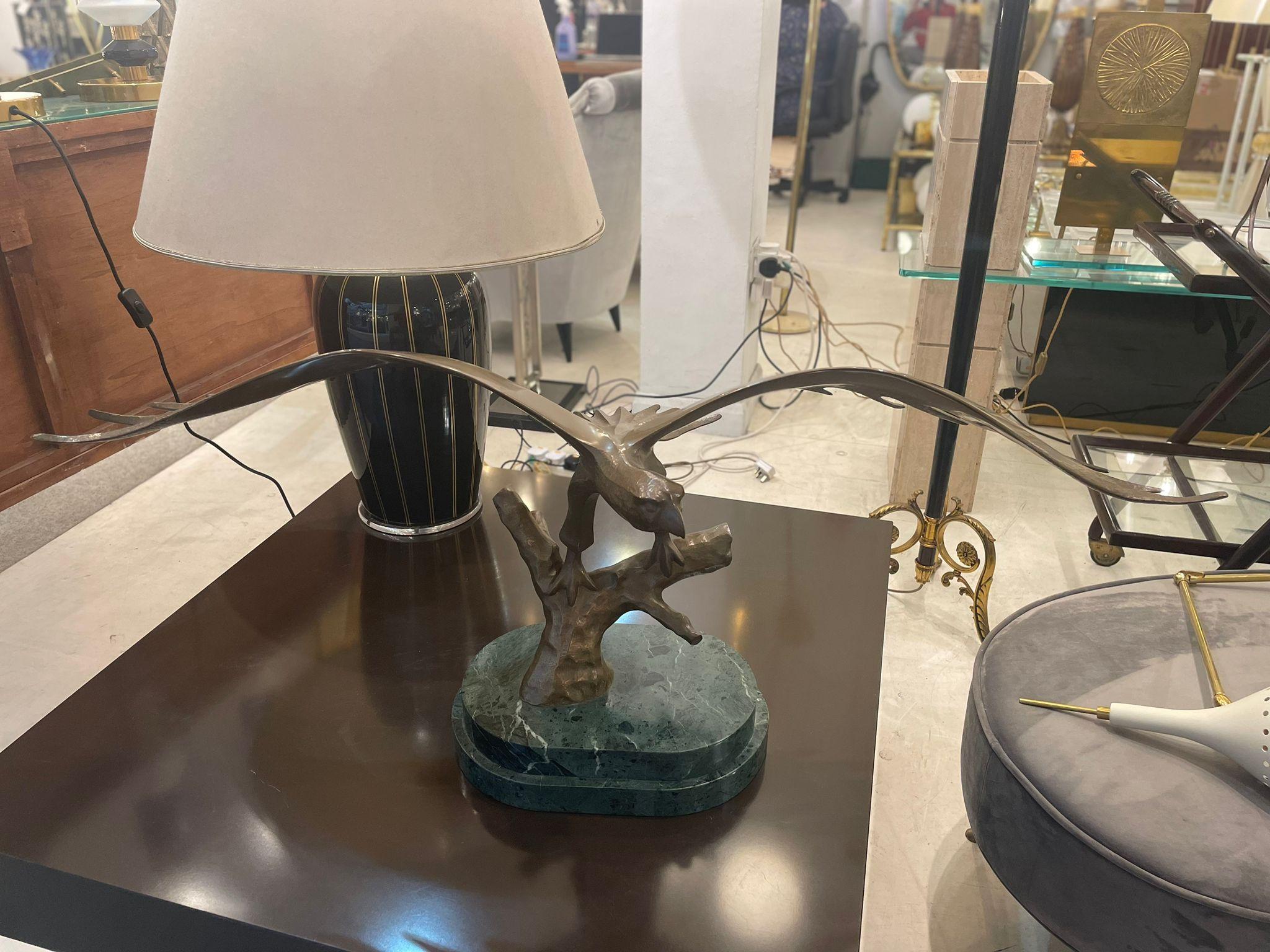 A bronze sculpture of an eagle about to take off mounted on a green marble base finely detailed, with foundry marks.
this wonderful Model of an Eagle, is bronze cast, modelled perched on a branch with its wings outstretched. The eagle measures 23cm