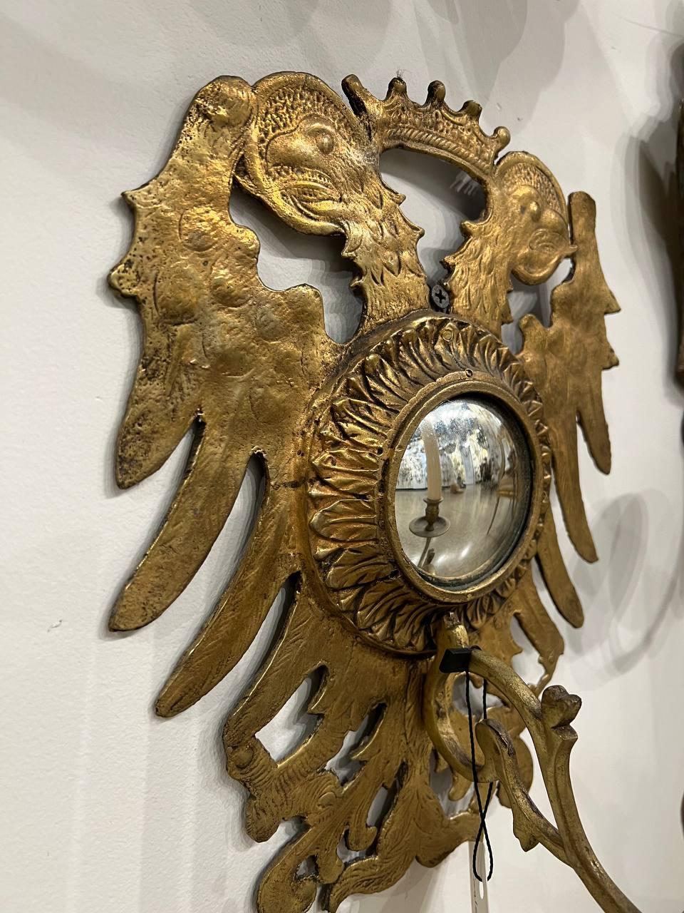 A pair of 1930's  Eagle design gilt bronze sconces with convex mirrored backplate, one light