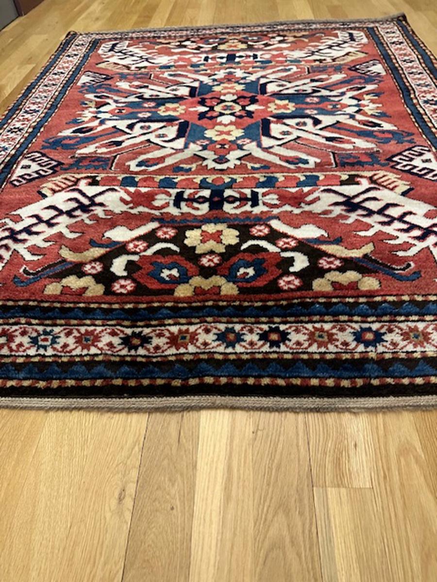 Eagle Kazak rug,or Chelaberd Kazak from southwest Caucasus

Age: circa 1880

Size: 6′.6″x5′.3″  x (198×160 cm)

The red field displays a central eagle medallion in ivory with a dark blue cruciform center and radially projecting florets.At each end