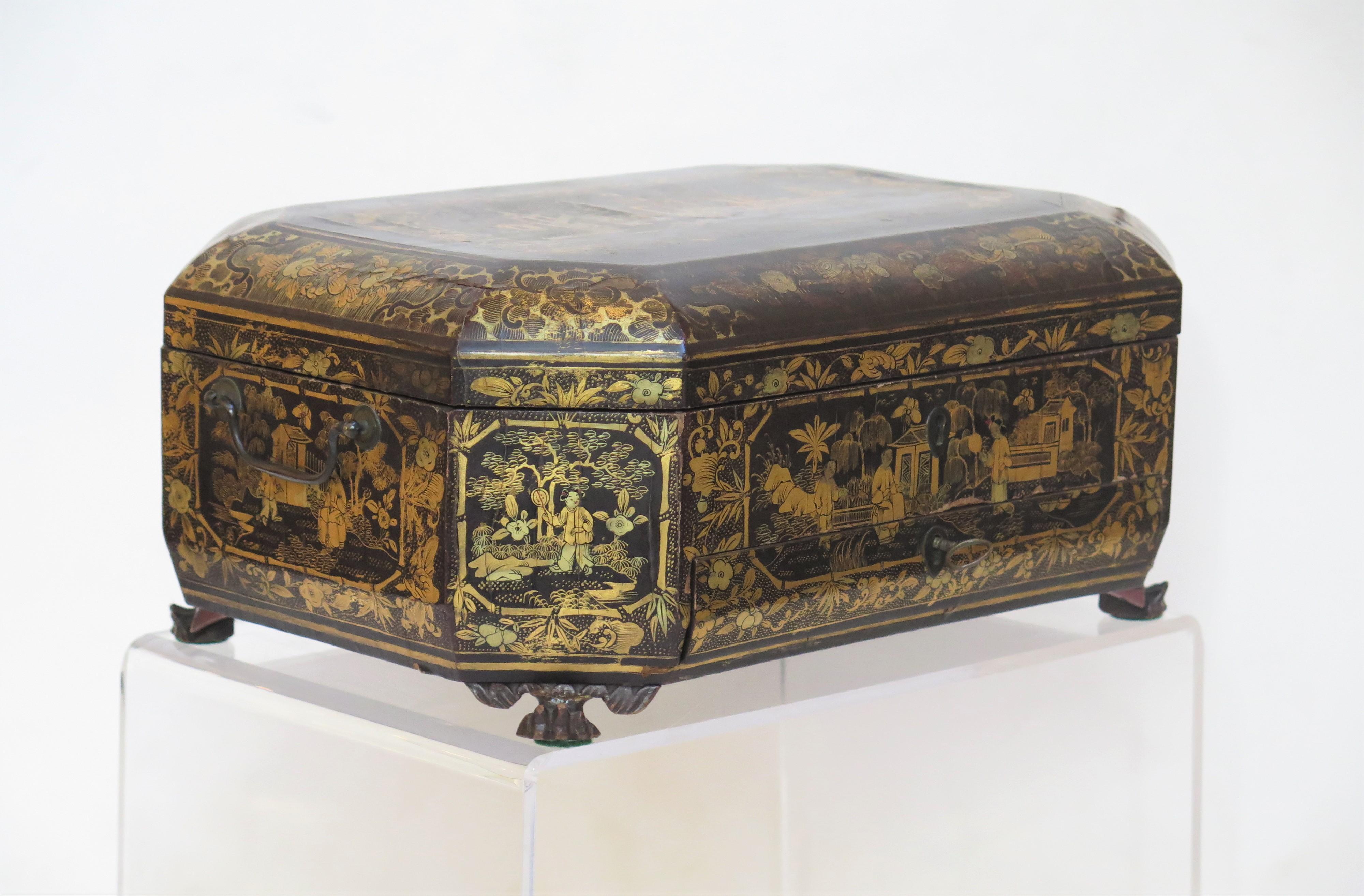 Ealy 19th Century chinese export lacquer sewing box, octagonal shape with feet, black lacquer with gilt decoration, worn on top. 