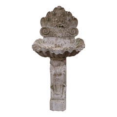 Ealy 20th Century French Carved Weathered Stone Wall Fountain with Shell Decor