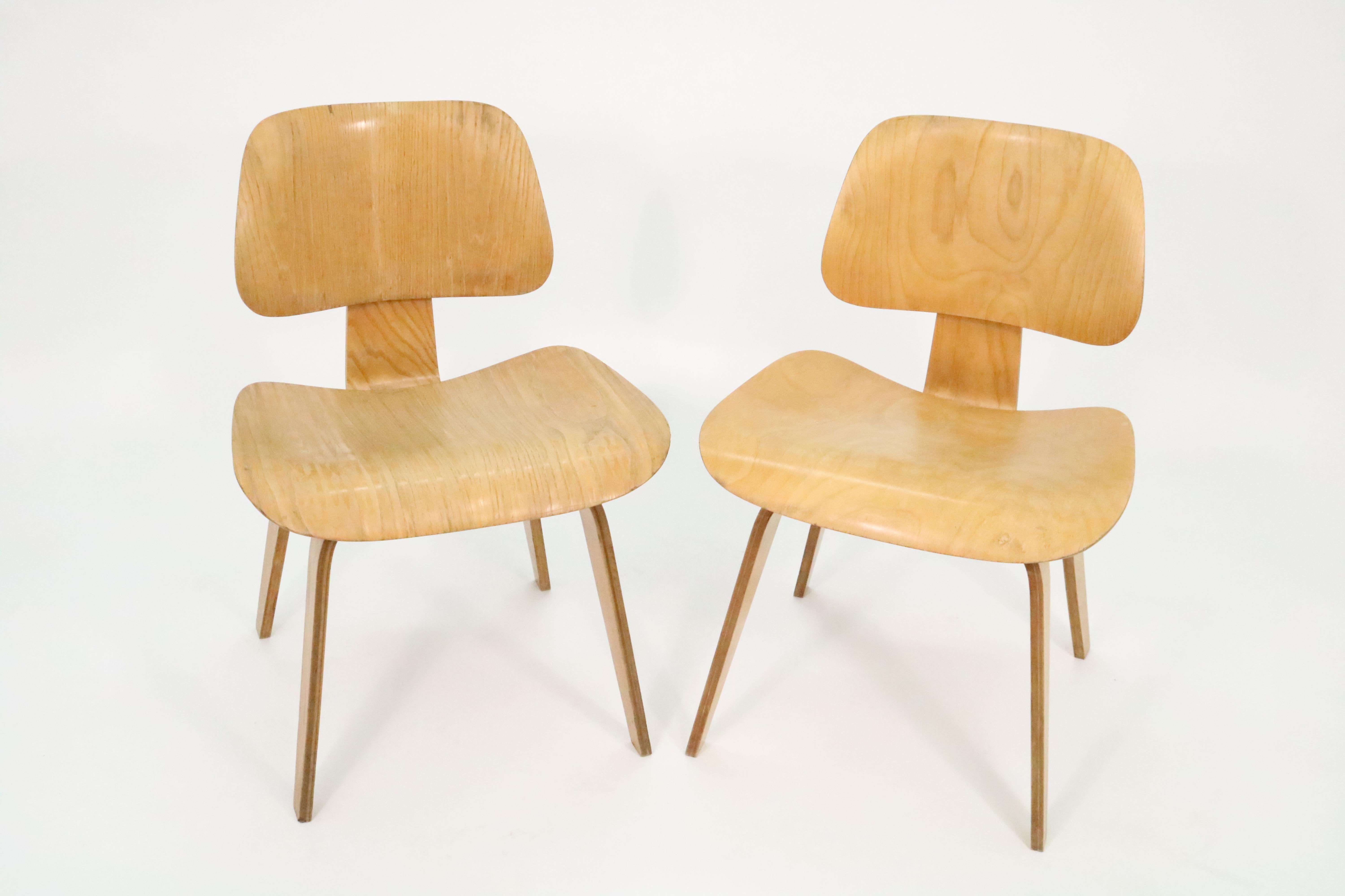 An early pair (1946-1949) of Evans production DCW chairs by Charles and Ray Eames for Herman Miller.

Original labels intact. The chairs have been thoroughly cleaned, but have not been refinished so that buyers can have their choice of maintaining