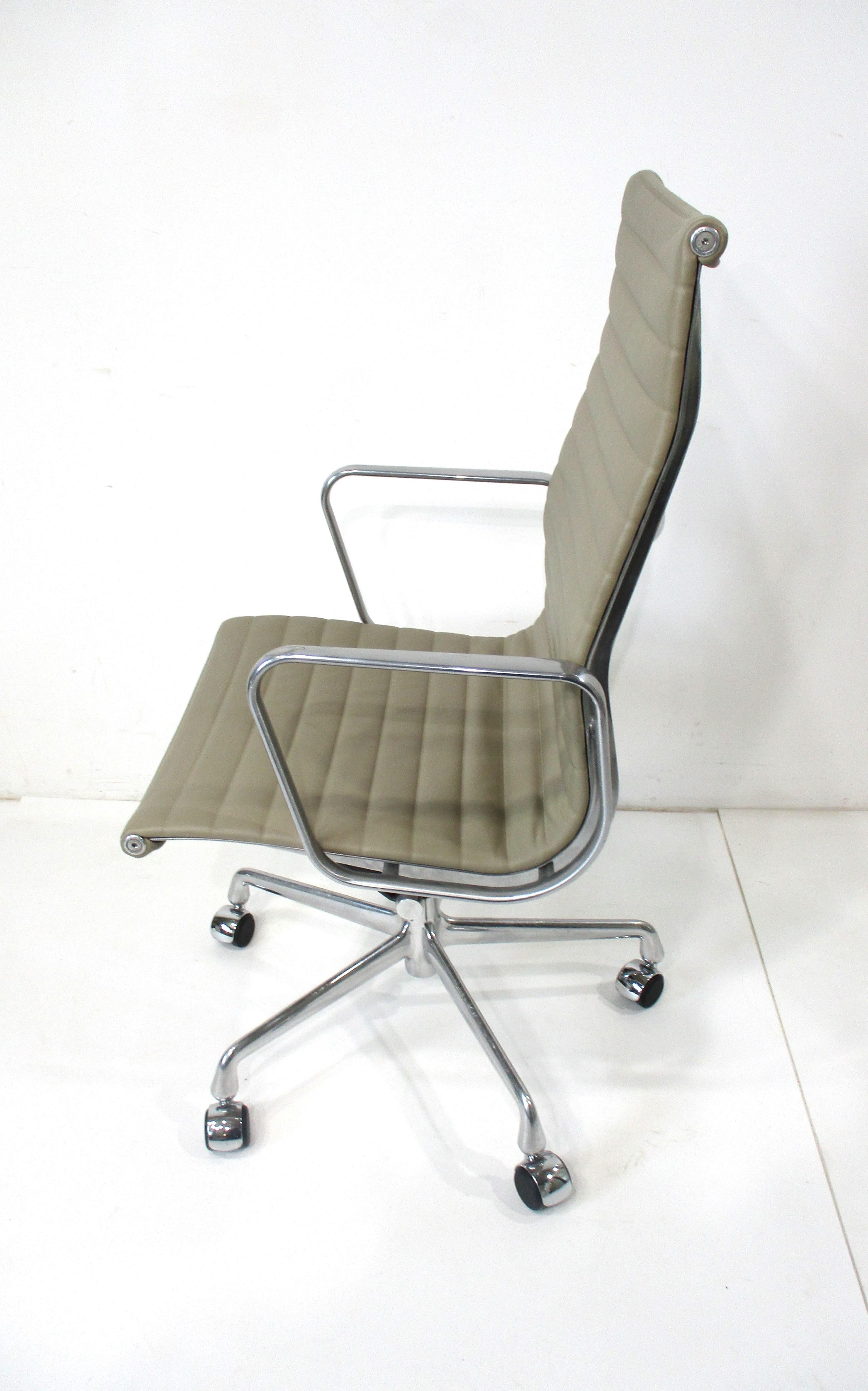 A 50th Anniversary edition 1958 - 2008 executive rolling high back aluminum group chair . Upholstered in a smooth and soft taupe spinney back leather only for this edition with polished aluminum star base . This iconic chair is still as fresh today
