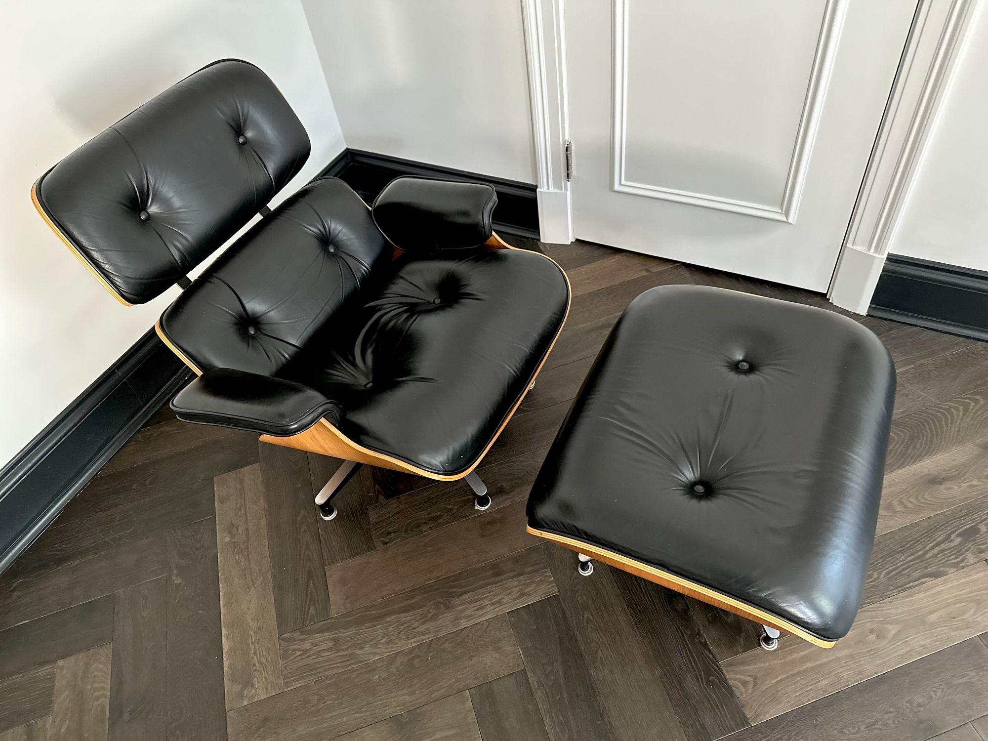 Eames 50th Anniversary Lounge Chair and Ottoman, 2006. Walnut with black leather.
Measures 31.5