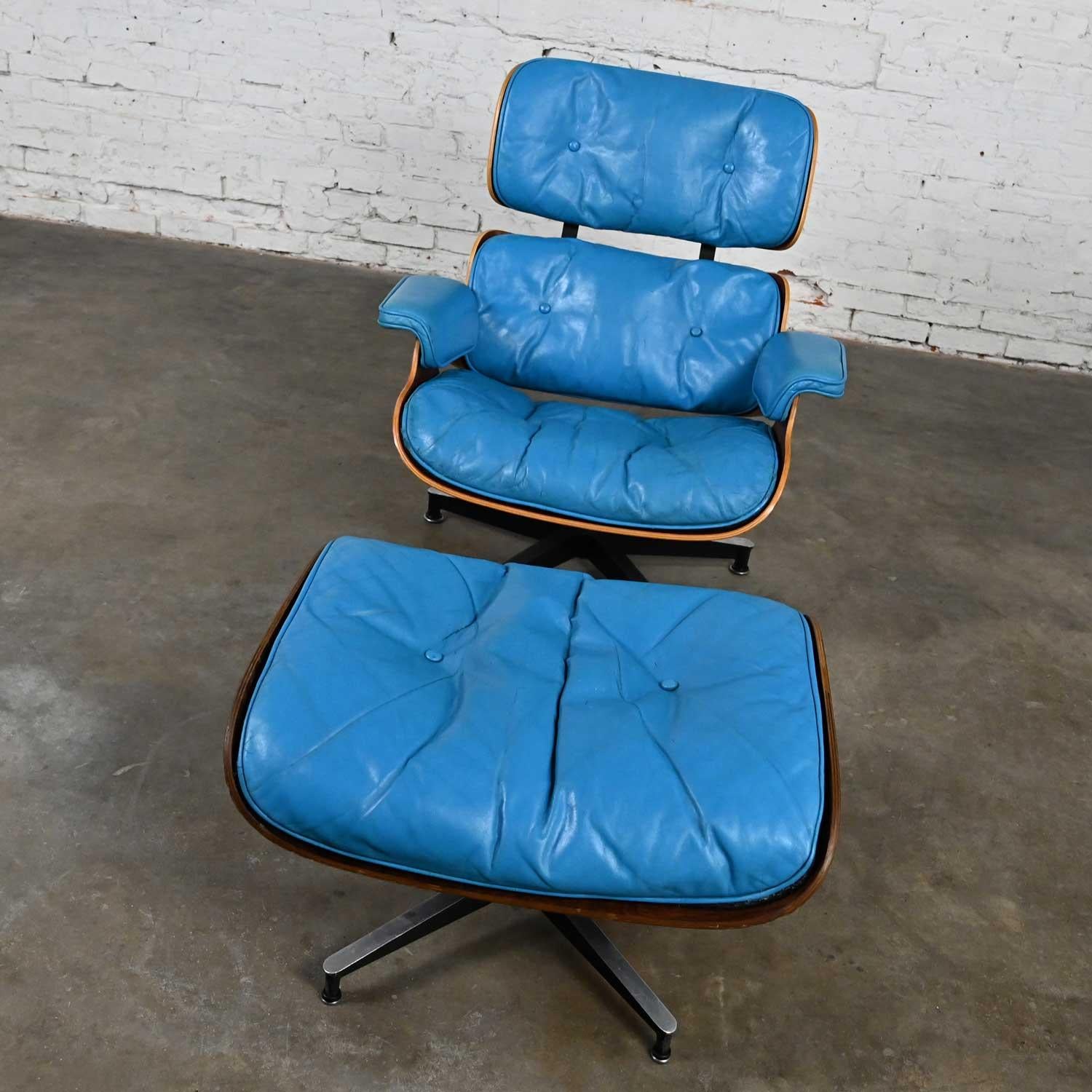 Fascinating vintage Eames 670 lounge chair and 671 ottoman in bright blue leather for Herman Miller. The seat frame is comprised of walnut, aluminum 5 prong base with black painted lower, and black shaft and the ottoman is comprised of a Rosewood