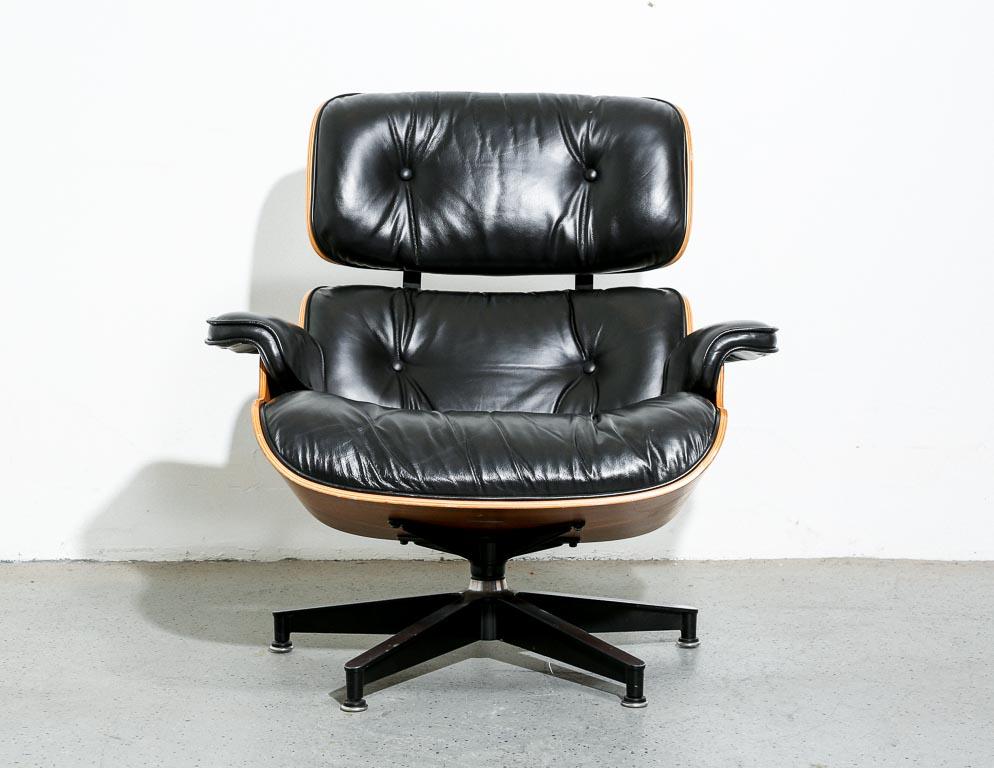Eames '670' lounge chair designed by Charles and Ray Eames for Herman Miller. Walnut molded plywood with black leather down-filled upholstery. Signed Herman Miller.

15