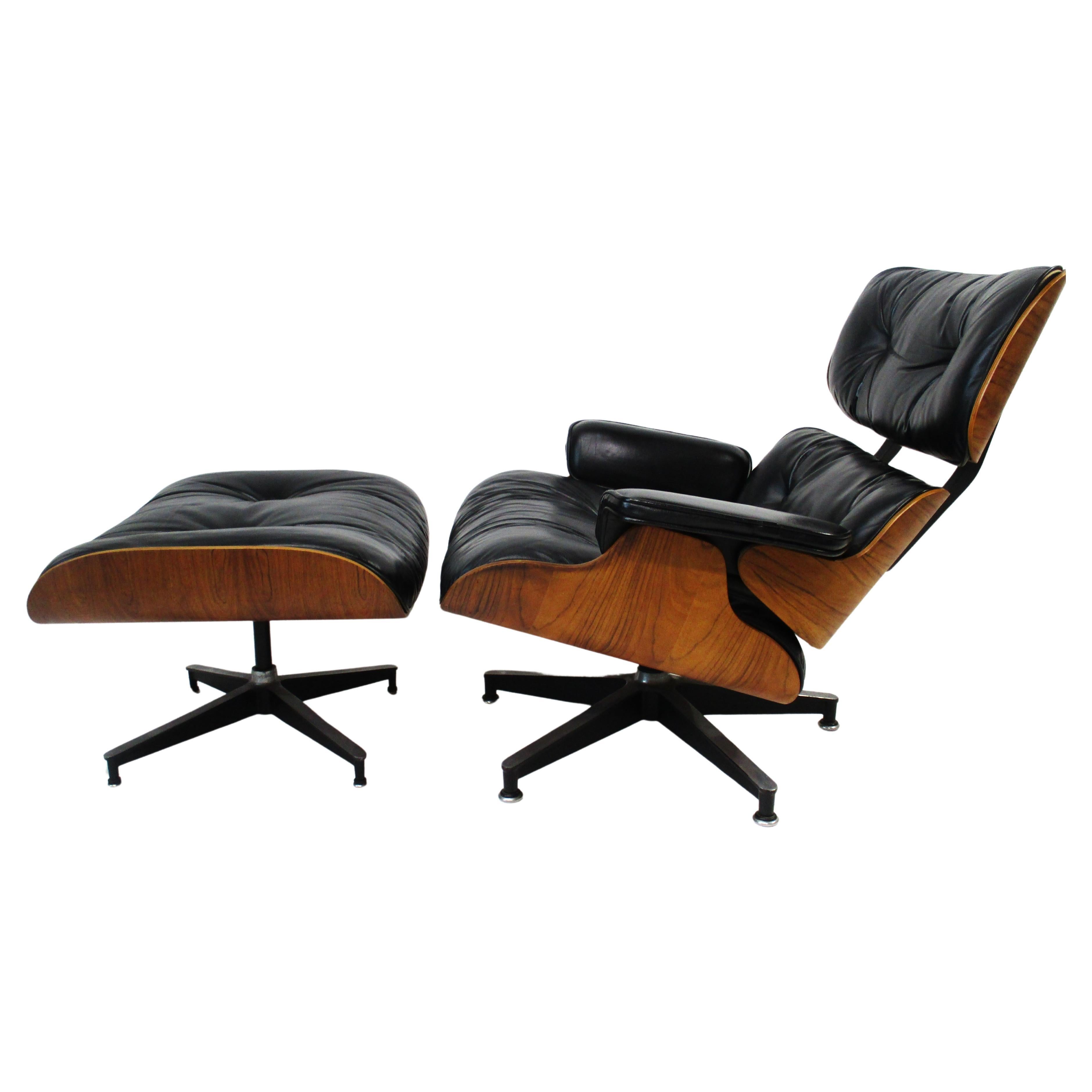 One of the most iconic designs of the Mid Century period the Eames 670 lounge chair with 671 ottoman . In the very desirable soft black leather and enhanced even further with a rich Brazilian rosewood frame sitting on cast aluminum star bases