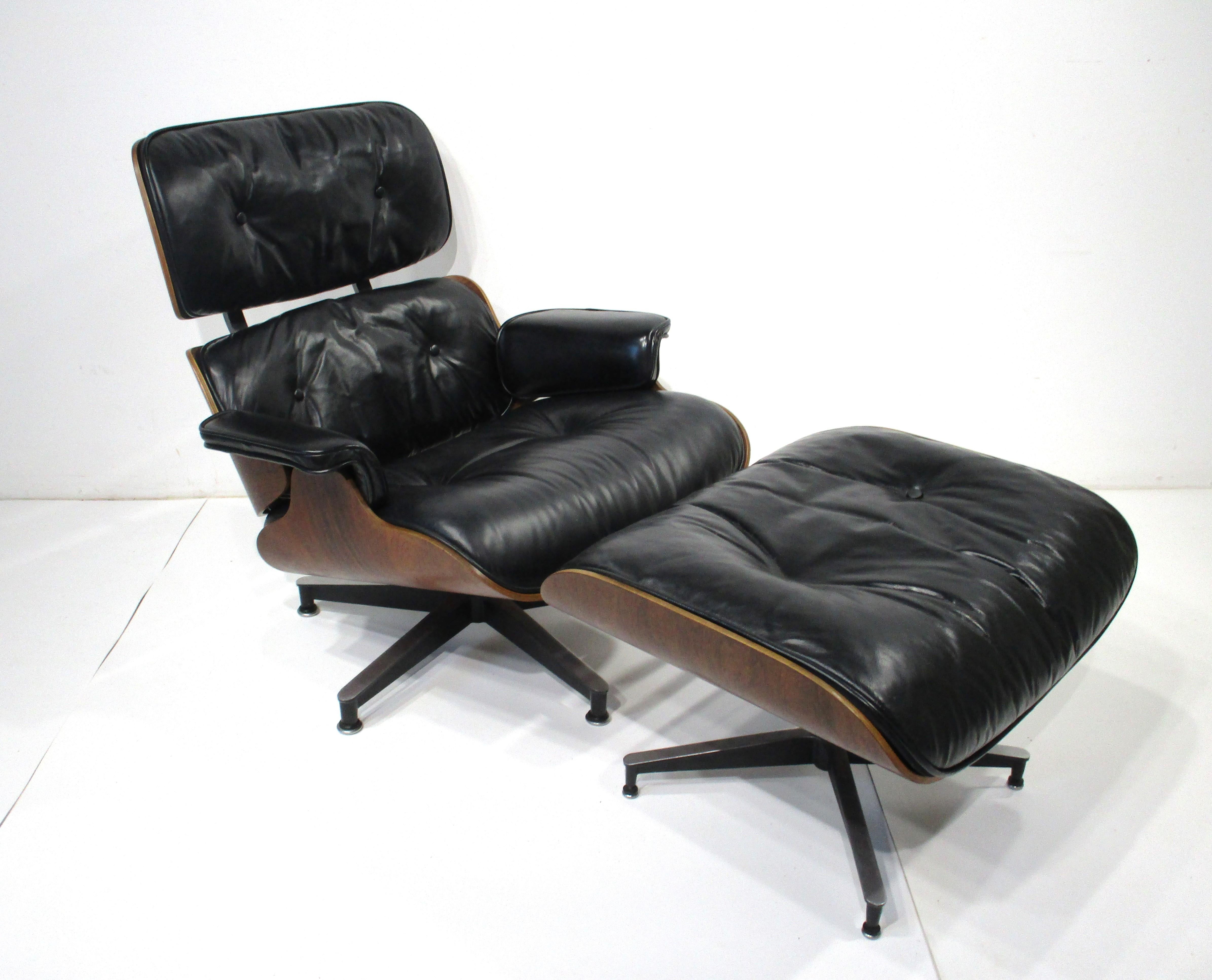 One of the most iconic designs from the Mid Century period the Eames 670 lounge chair with 671 ottoman .In the very desirable soft black leather matched with a Brazilian rosewood frame sitting on cast aluminum star bases . Manufactured by the Herman