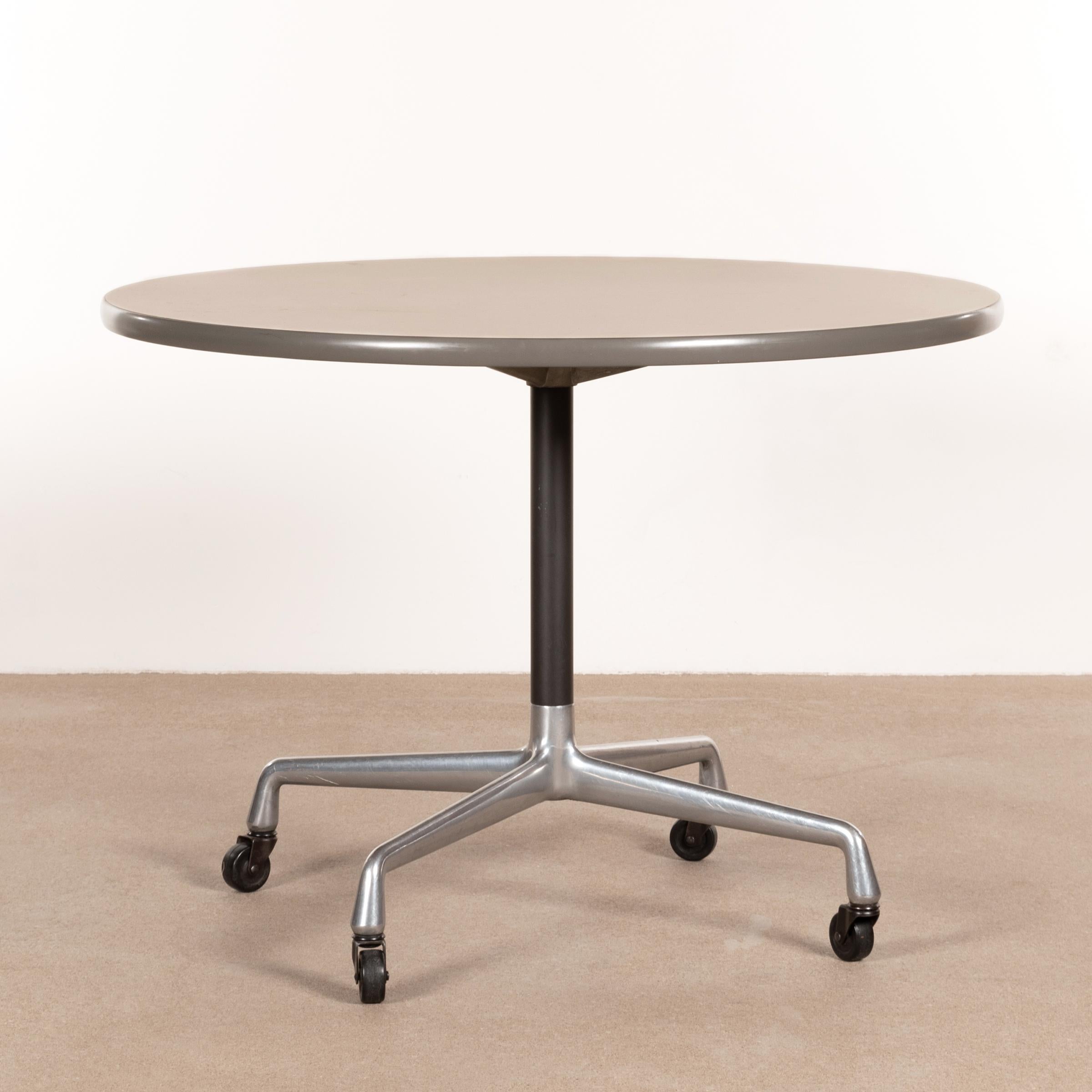 Easy to move small table from the Herman Miller Action Office Series (model AO084M8). Polished aluminum base with casters and formica table top in natural tone finished with a grey vinyl edge. All in good original condition with traces of use.