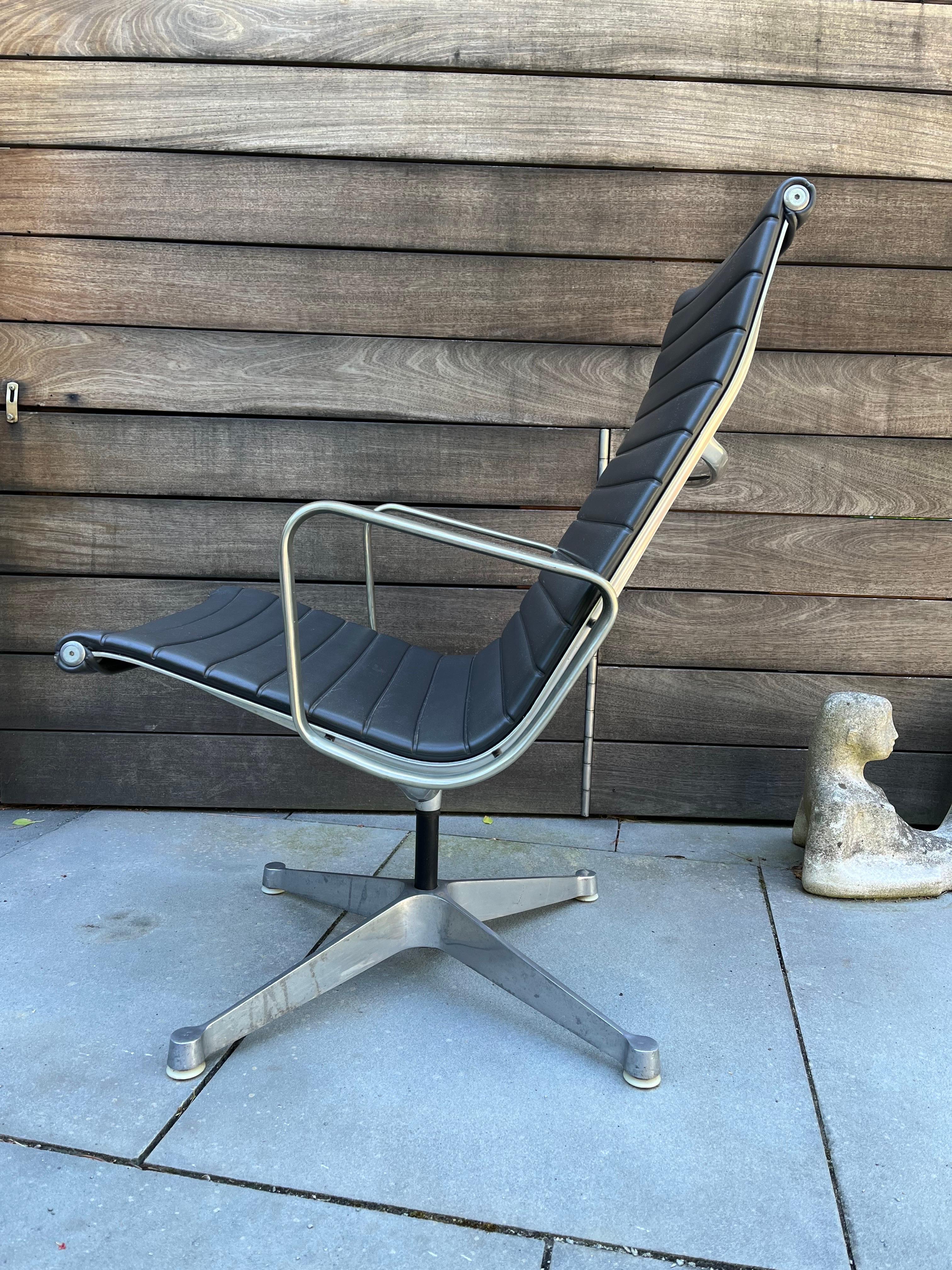 Eames Aluminum Group Chair by Herman Miller. Older 4 prong Base design. Presents very well, has one area of damage front left corner as seen in photo. This model does not tilt or go up and down. Swivel works well.