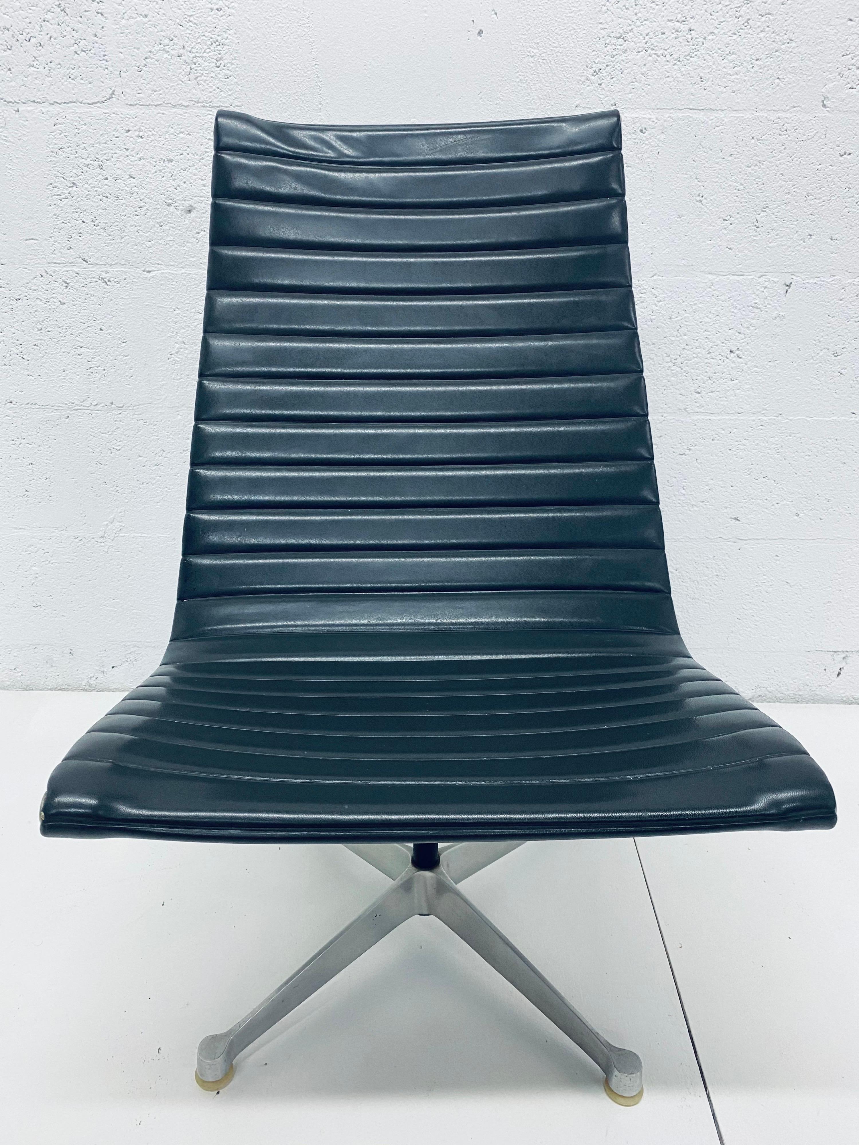 Early edition Charles and Ray Eames Aluminum Group lounge chair with dark gray eco-leather seat on aluminum swivel base for Herman Miller, circa 1950-60s.
