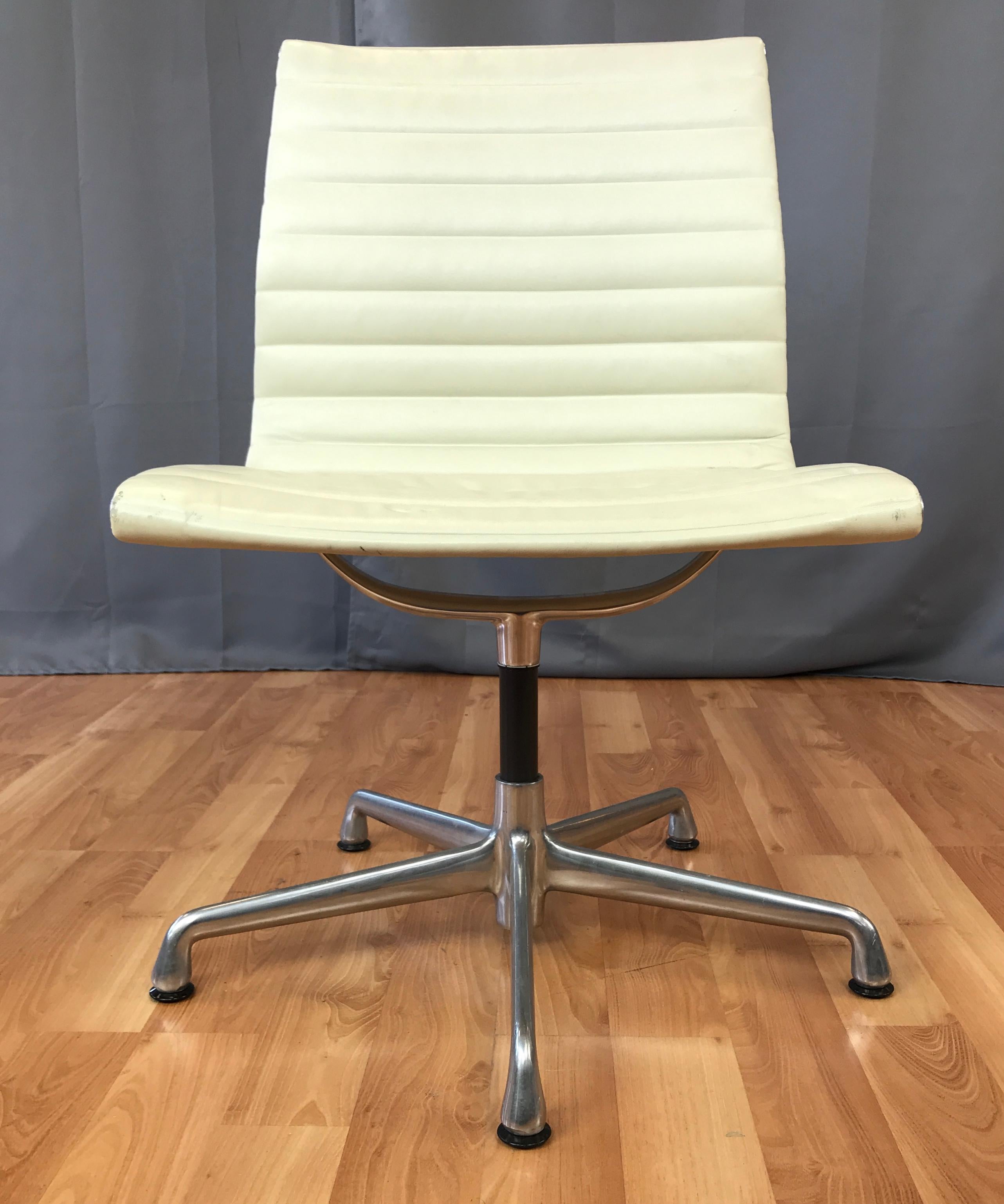 Design by Charles and Ray Eames, aluminum group side chair for Herman Miller.
First designed in 1957, this one is newer circa 2007, with cream color leather. Has five star base.
