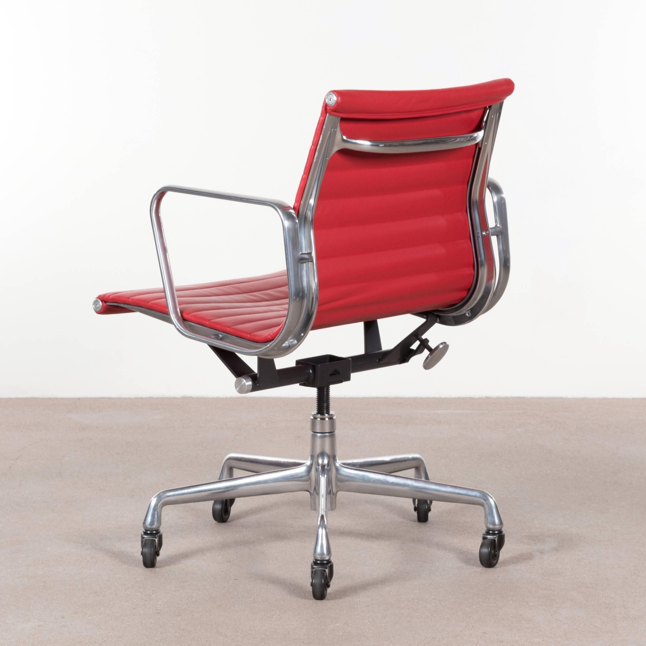 Eames EA335 management office chair in bright red leather with five-star base, spindle and tilt-swivel mechanism. Very good / excellent original condition signed with manufacturer's label. Multiple chairs available.