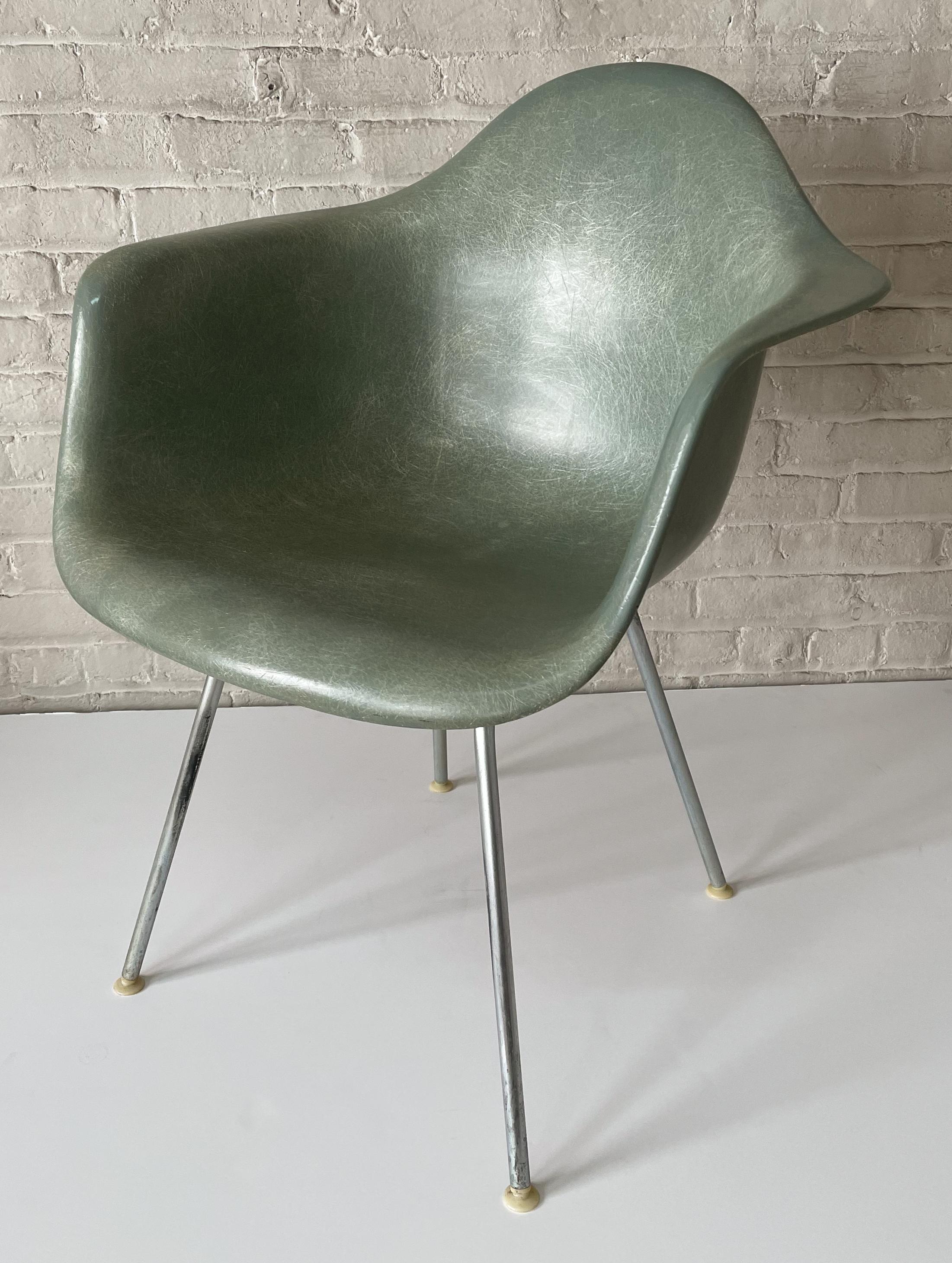 DAX chair of molded fiberglass with zinc-plated steel legs, plastic glides, and rubber shock mounts. An iconic 1950 design by Charles and Ray Eames for Herman miller in the desirable seafoam green color. This example dated 1959. In fine original