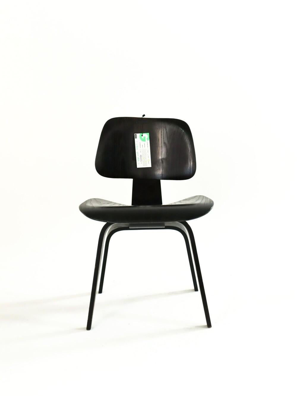 Early Evans Version Eames DCW. This collector's piece is labeled underneath and has the large single back mount. 

