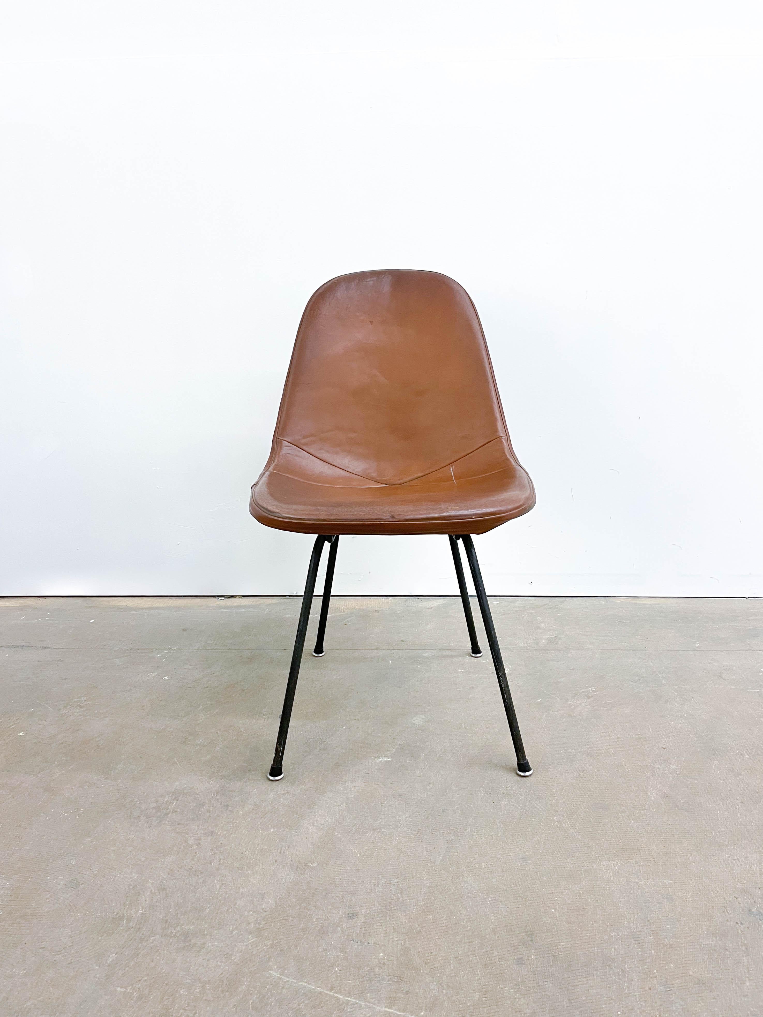 This is an attractive leather-covered wire chair designed by Ray and Charles Eames and made by Herman Miller in the 1960s. The first thing you will notice is the beautifully worn leather -- sometimes called the postman's bag for its great patina and