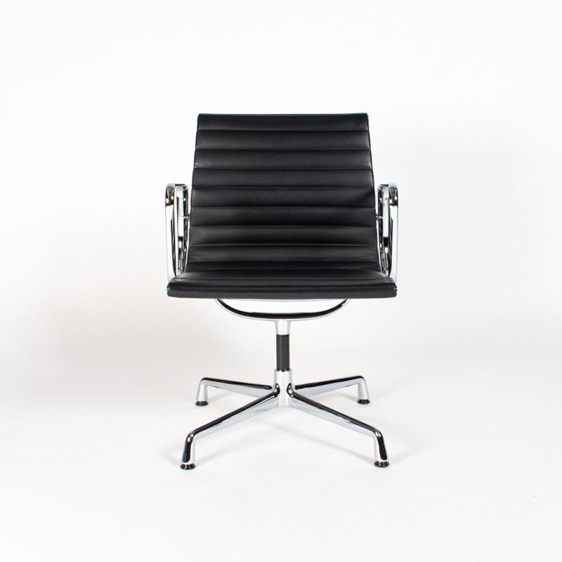 Comfortable and iconic dining chair designed by Charles & Ray Eames and manufactured by Vitra. Lightweight chrome-plated aluminum frame with swivel mechanism and black leather upholstery all in very good / excellent condition with minimal signs of