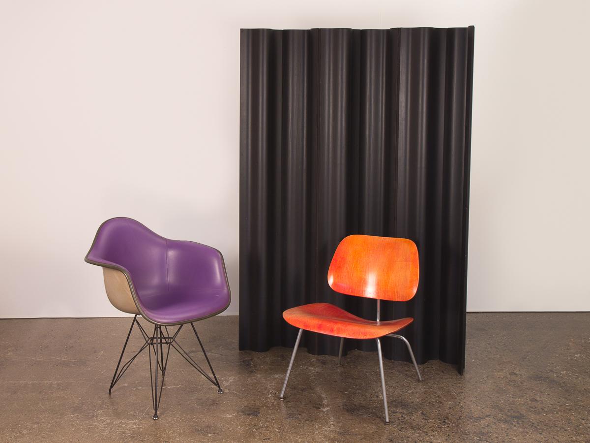 Charles & Ray Eames ebonized folding wood screen. Amazing sculptural room divider that undulates in space. The freestanding panels of molded ash are attached with fabric making the screen adjustable. Our example is from the 1950s and is in excellent