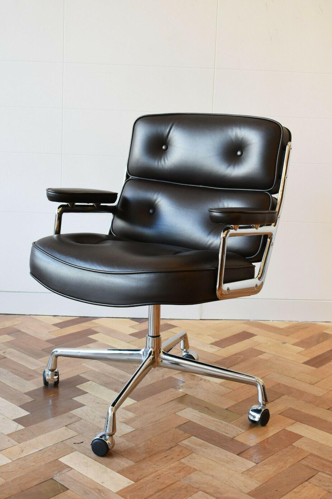 Eames ES 108 Lobby Time Life executive lobby chair for Vitra in Chocolate Brown, circa 2009. Originally designed in 1960s, this chair was designed to furnish lobby areas in New York's Time Life Building. 

Iconic and elegant, the Lobby Chair's