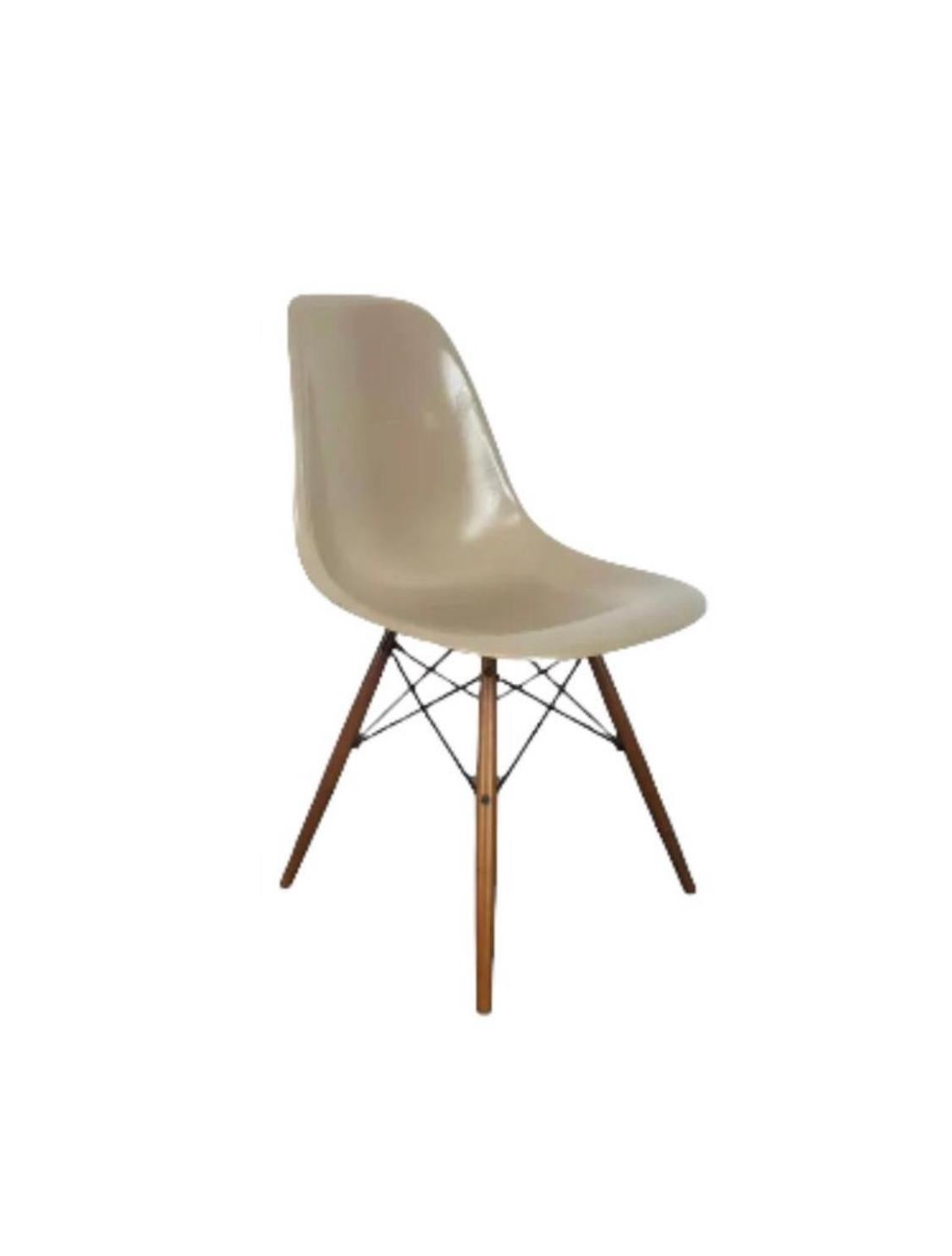 Herman Miller fiberglass dining chairs designed by Charles and Ray Eames. All in matching “greige” color, which is elegant and complements all decor and color schemes. Signed and guaranteed authentic. Complete with brand new American made walnut