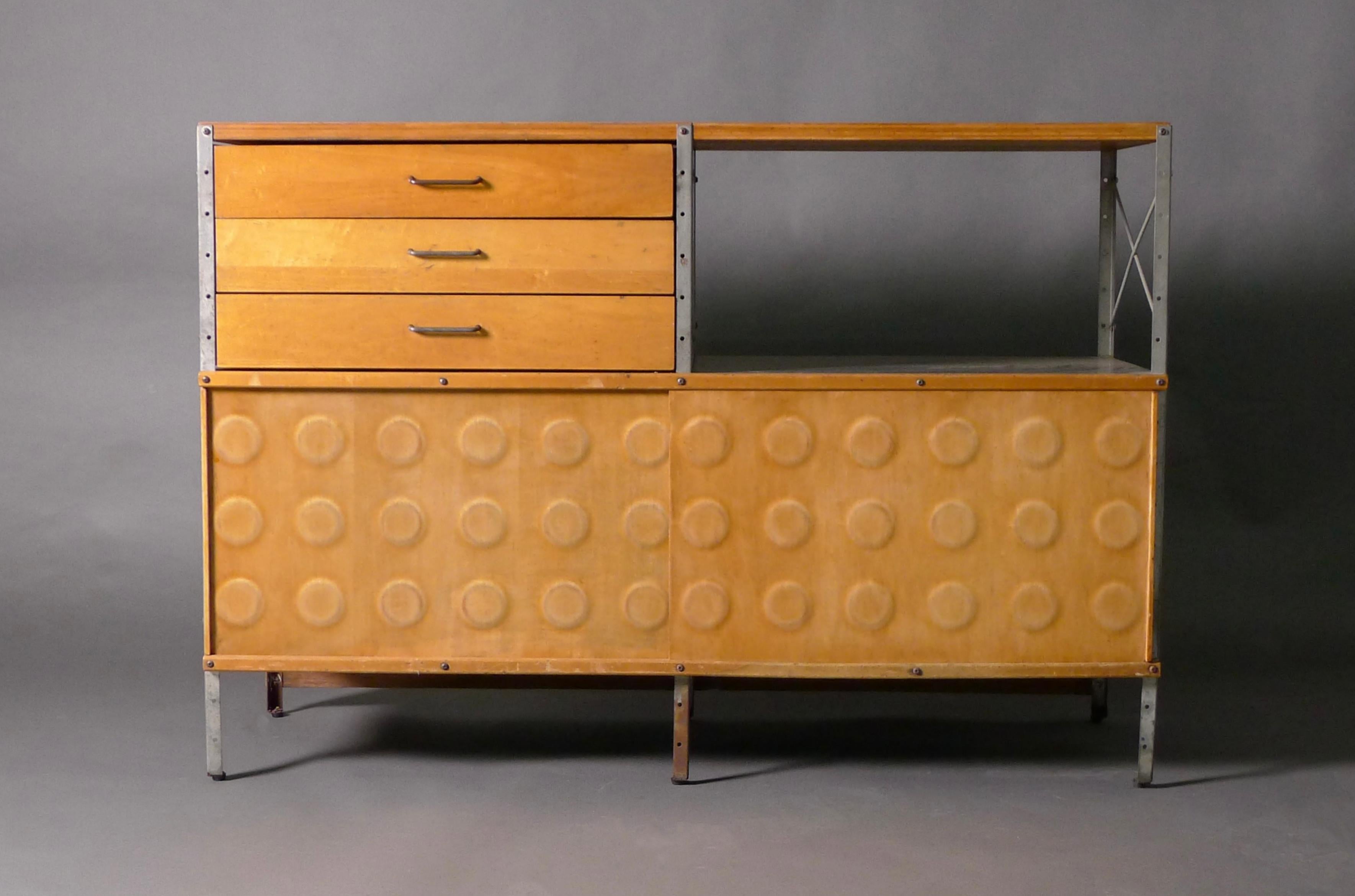 First generation Eames storage unit (ESU) model 220-C 
Birch ply top and plywood dimple doors with coloured masonite panels to sides and back
Fitted three black painted ply drawers with metal sides
119cm wide, 41cm deep, 82cm high

The first