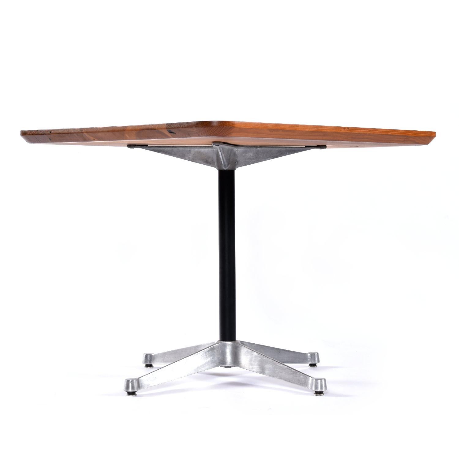 Vintage Eames table by Herman Miller with angular aluminum base. The 32″ square table is compact and versatile. Use this table in the dining room, kitchen, or office. The table was first designed by Charles and Ray Eames in 1964. The elegant yet