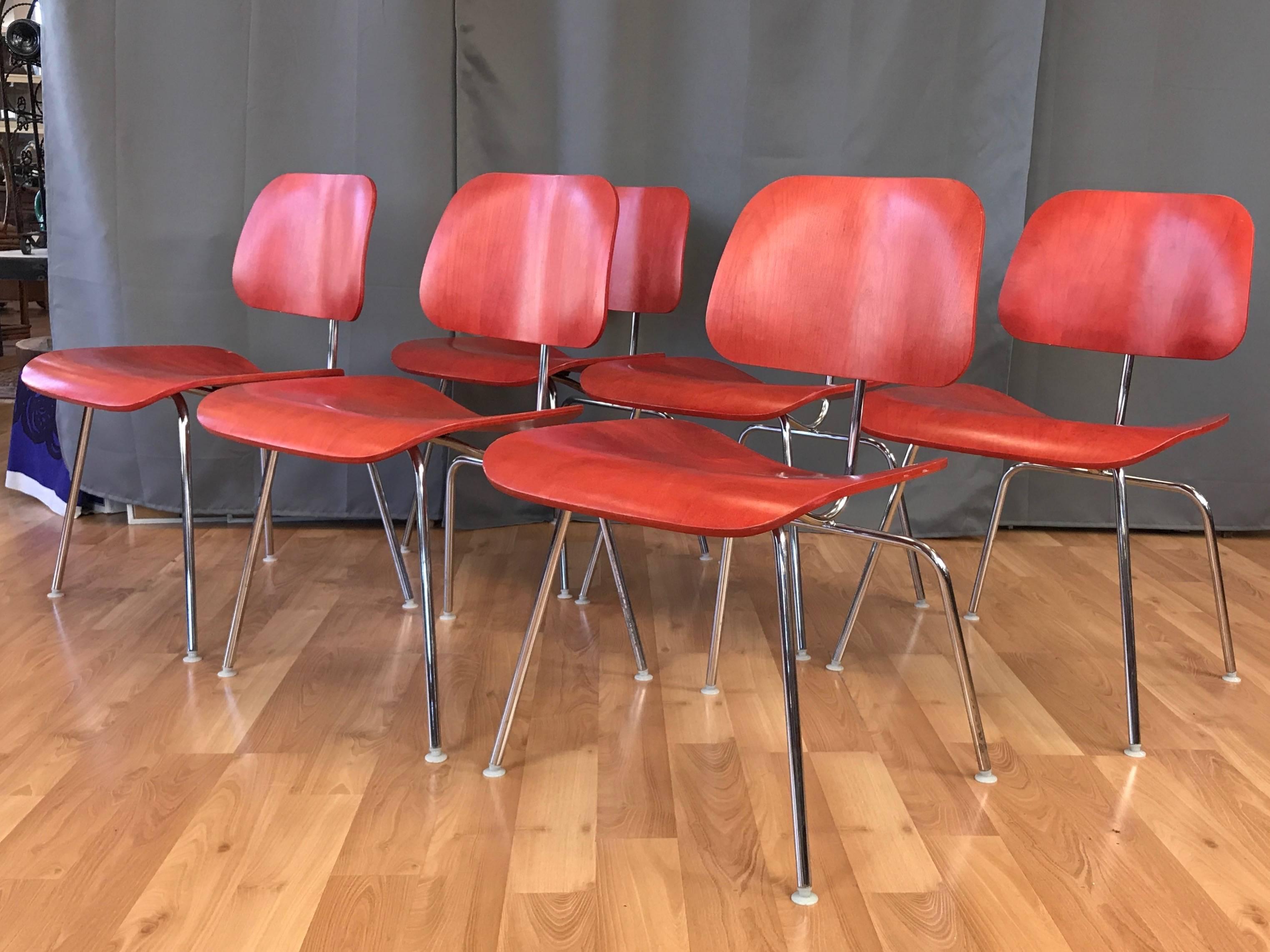 ***We only have one chair left***

A newer production aniline red DCM chair by Charles and Ray Eames for Herman Miller, offered individually.

Introduced in 1946, this example of the quintessential mid-century modern design classic was produced in