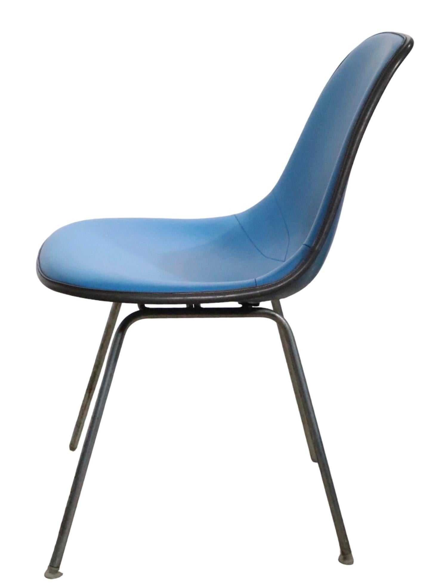 Classic Eames DSX chair in original blue vinyl upholstery, with black trim,  over a blue fiberglass shell. The chair its in very good, original, clean and ready to use conditional the plastic feet glides are present, photoshop tends t remove them