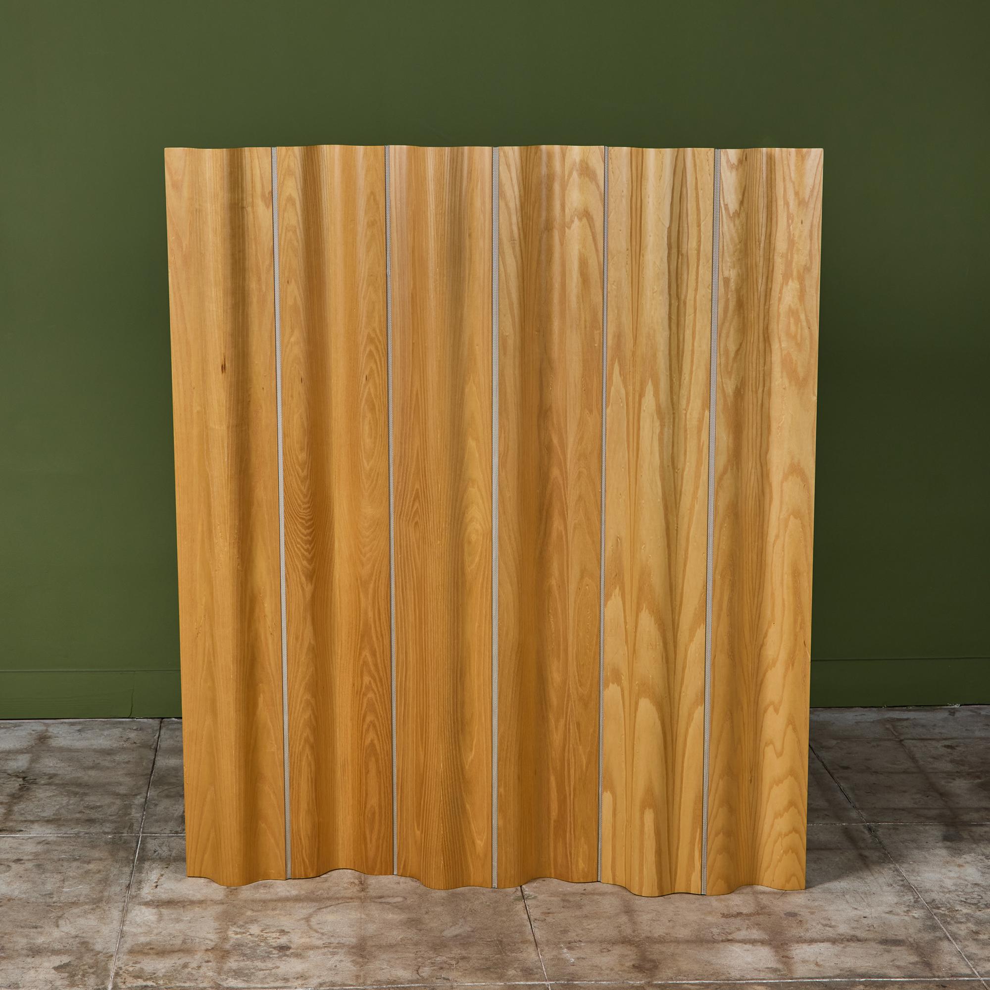 Ray and Charles Eames’ iconic folding screen, FSW-6, for Herman Miller takes the inspiration for its undulating shape from the folds of heavy drapery. Composed of articulated panels of curved plywood, sandwiched between highly figured maple veneers,