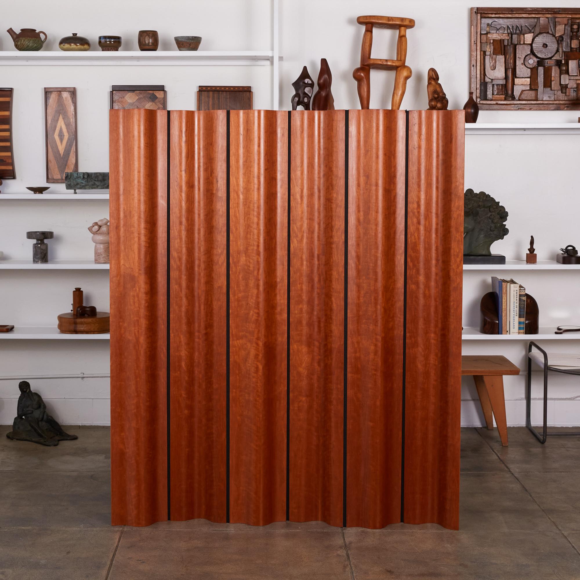 Ray and Charles Eames’ iconic folding screen, FSW-6, for Herman Miller takes the inspiration for its undulating shape from the folds of heavy drapery. Composed of articulated panels of curved plywood, sandwiched between highly figured cherry