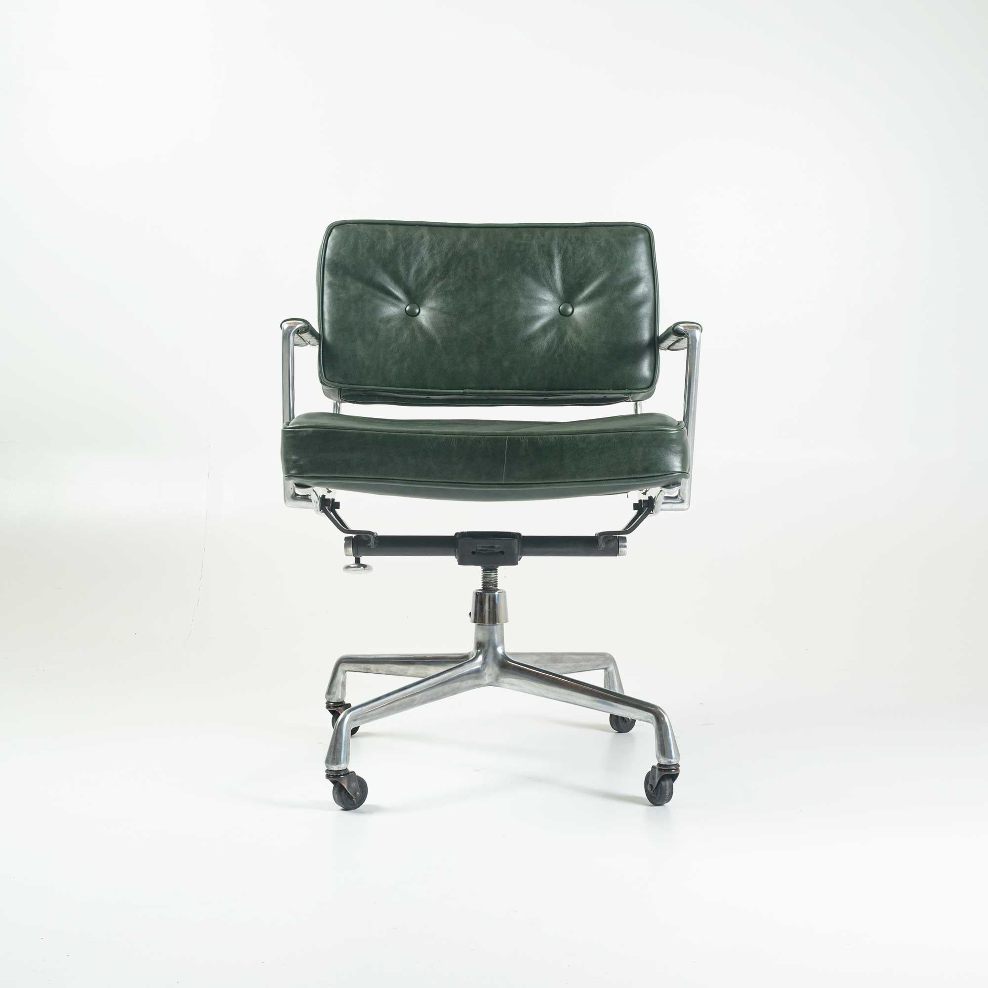 Eames Intermediate chair with arms version, early model, reupholstered in British racing green leather.
    