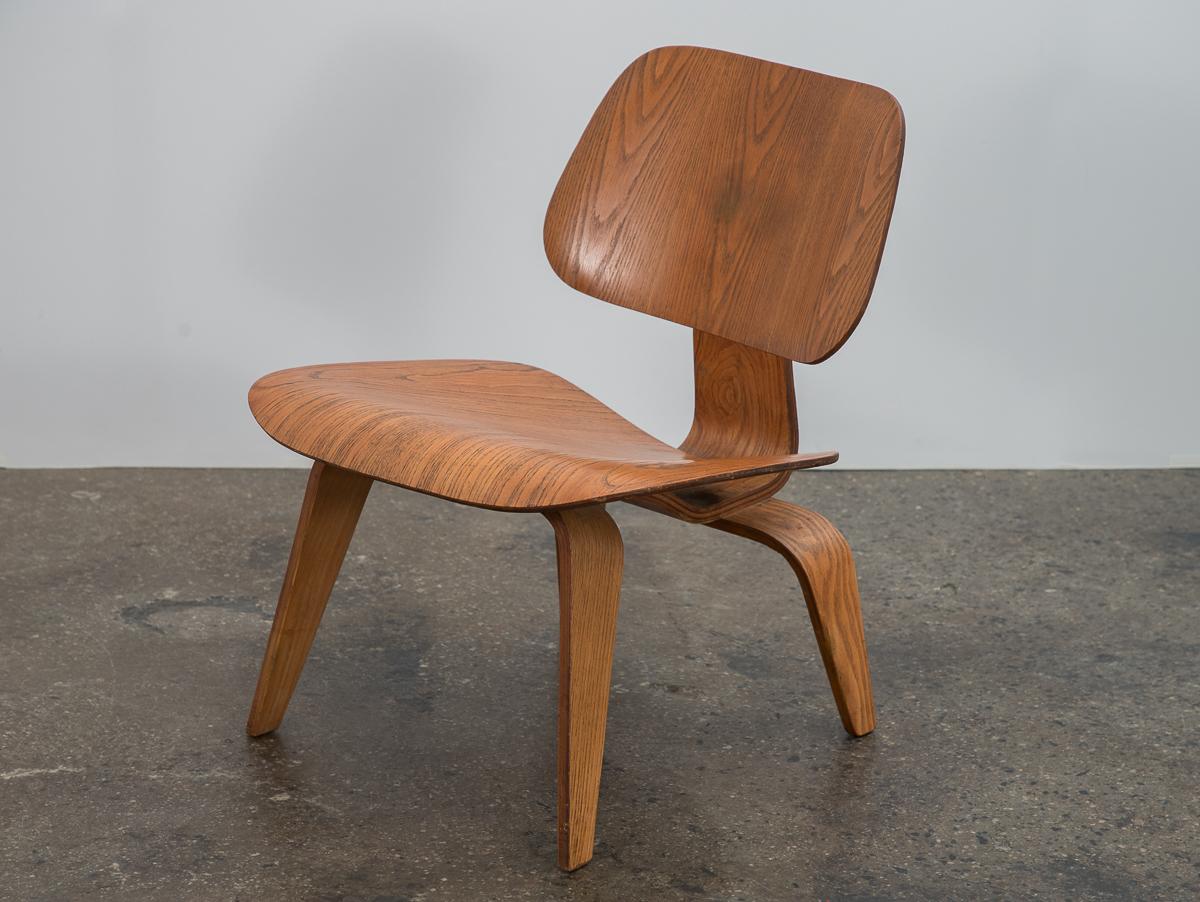 Original LCW lounge chair, designed by Charles and Ray Eames for Herman Miller. Molded plywood with strongly figured ash veneer, sculpted in a low-slung profile. Legs and seat edges are very clean with no major chips. Structurally sound--shock