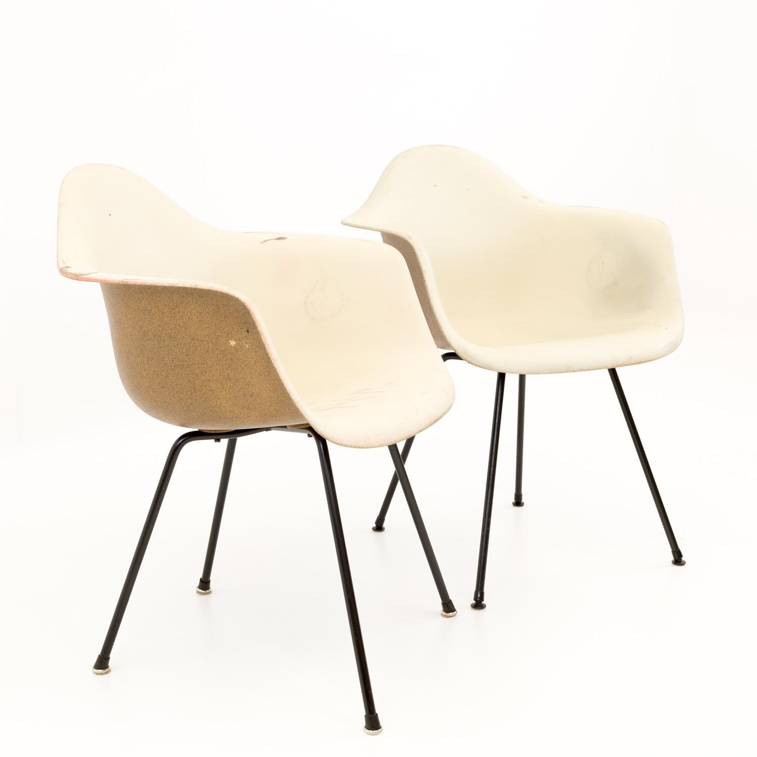 Eames for Herman Miller mid century molded plastic x-base shell chairs - pair.

Measures: 24.75 wide x 22.5 deep x 31 high with a seat height of 16.5 inches.

All pieces of furniture can be had in what we call restored vintage condition. That