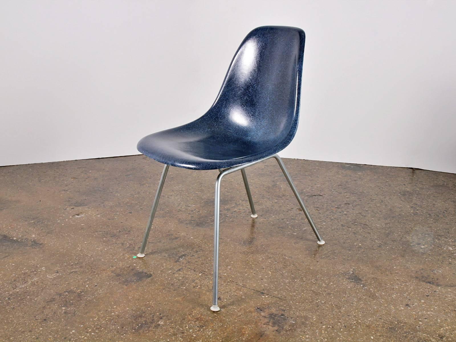 Original Navy Blue Molded Fiberglass Shell Chair, designed by Charles and Ray Eames for Herman Miller. Vintage shell chairs are prized for their attractive patina, distinct thread texture and beautiful depth of color seen in the fiberglass material.