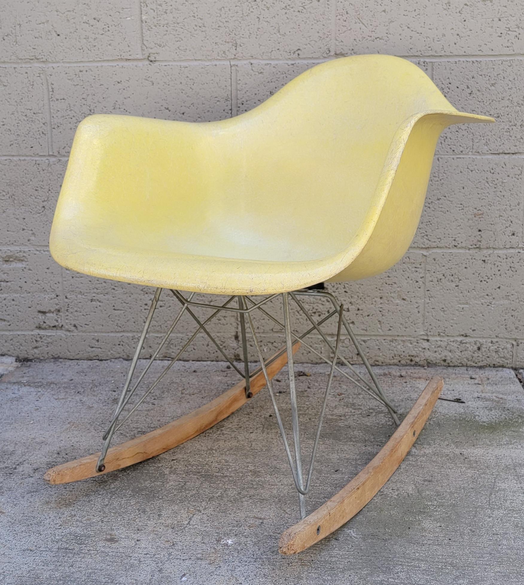 Authentic, early lemon yellow formed fiberglass RAR rocking chair designed by Charles and Ray Eames for Herman Miller. Dated 1957. Original base. Original vintage condition with imperfections from use and history. Appears a puppy? broke in his teeth