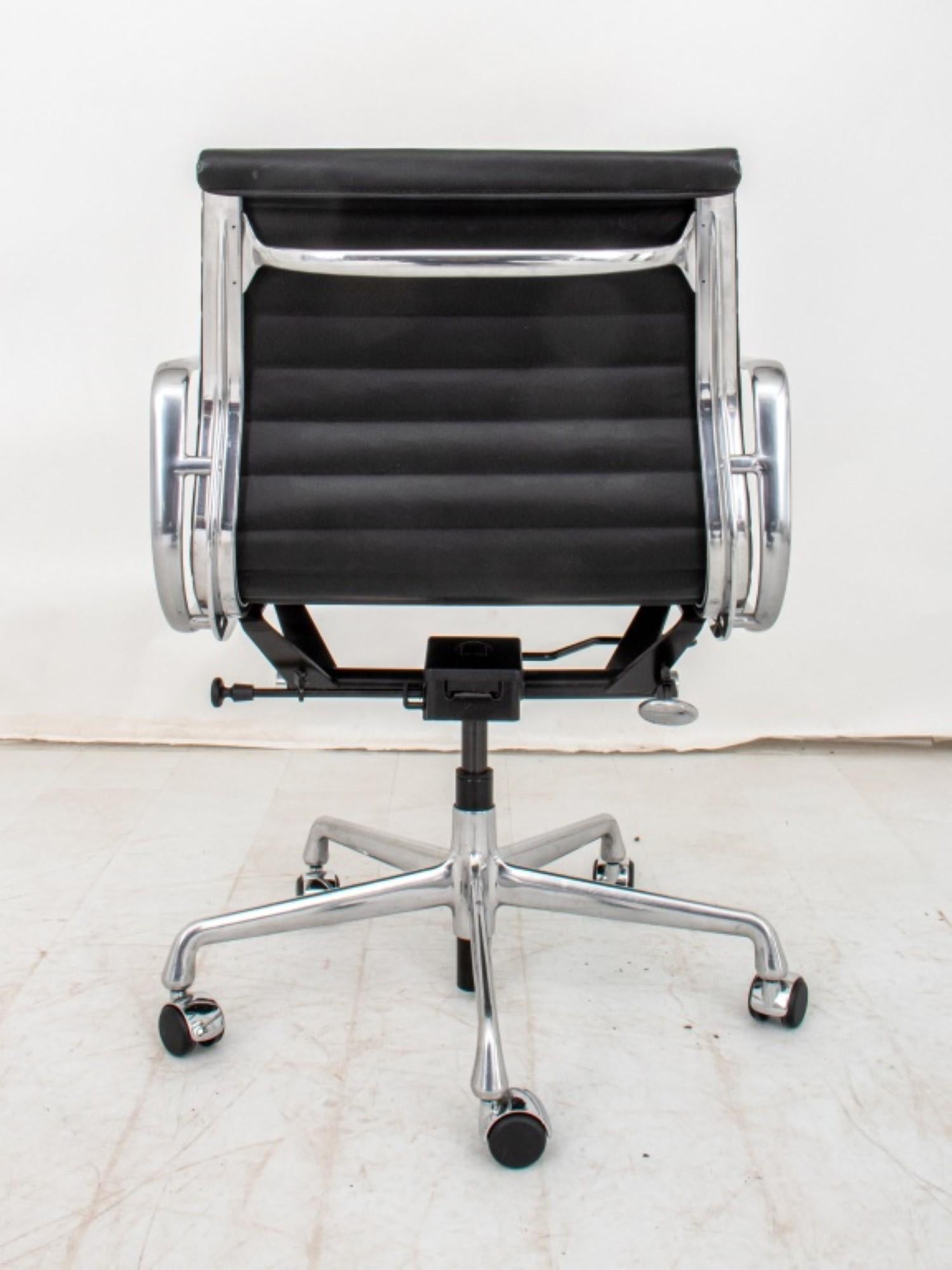 The Charles and Ray Eames for Herman Miller Chrome and Ribbed Vinyl Office Swivel Chair has overall dimensions of approximately 34.25 inches in height, 22.75 inches in width, and 21 inches in depth. This modern office chair is mounted on five