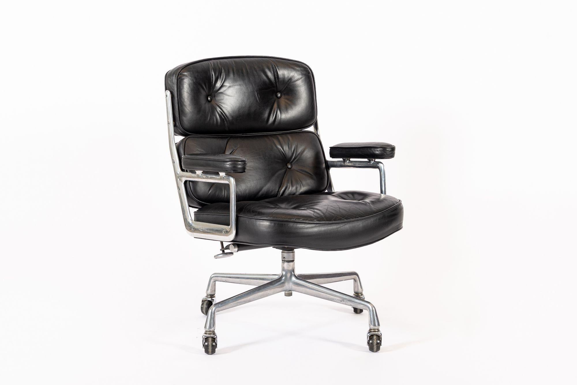 This vintage mid century modern black Model 3475 Eames Time Life Lobby Chair designed by Charles & Ray Eames for Herman Miller was produced in 1981. This classic office chair features original black leather upholstery and four-star cast aluminum