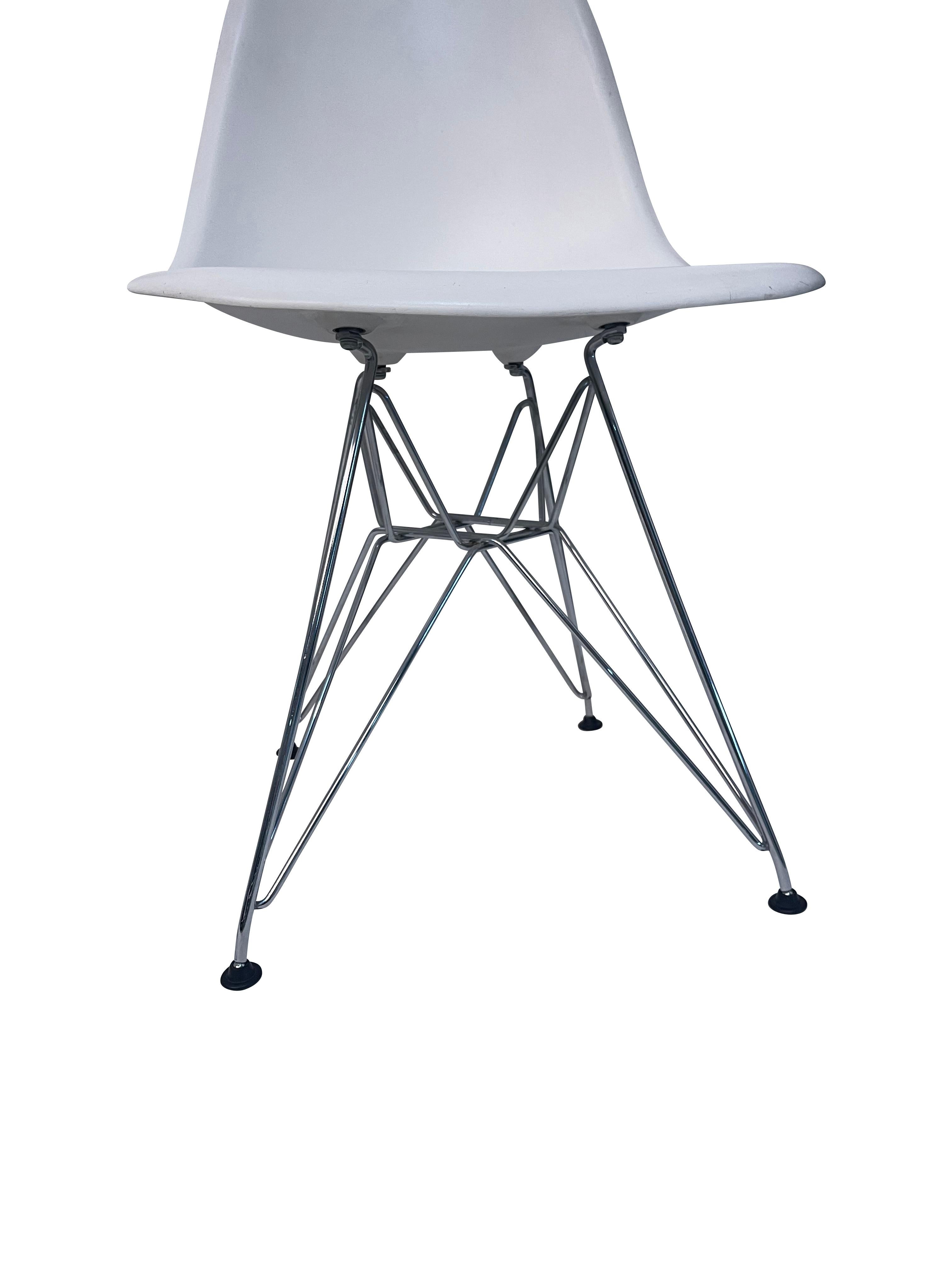 Eames for Knoll molded white plastic chairs with iconic stainless steel Eiffel Tour bases. Marked Eames for Knoll  A more compact yet exceedingly versatile seating option, the Eames® Molded Plastic Side Chair Wire Base from Herman Miller® is crafted