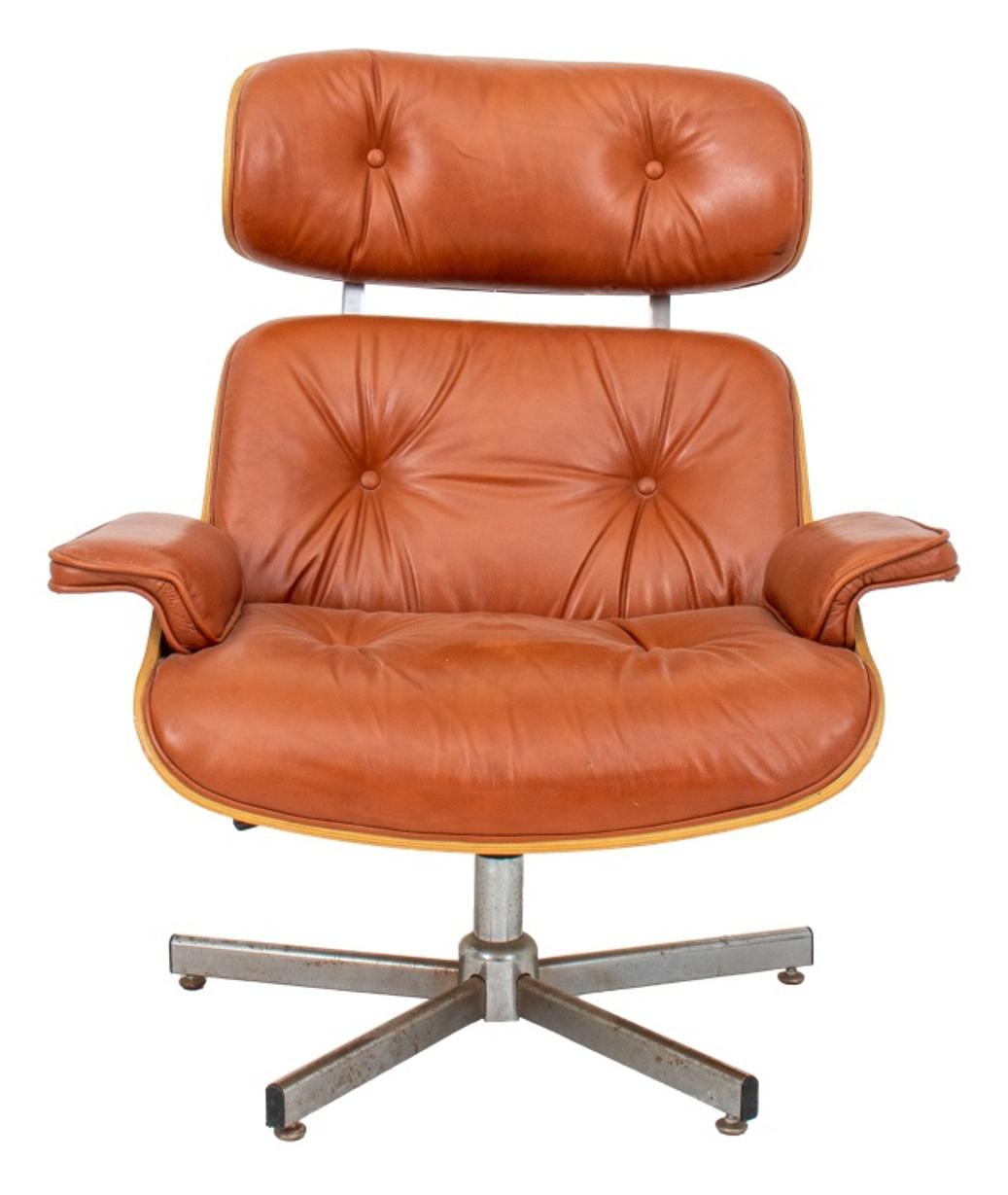 Charles Eames for Herman Miller manner cognac leather upholstered wood arm or desk chair on five wheels.

Dimensions: 29.5