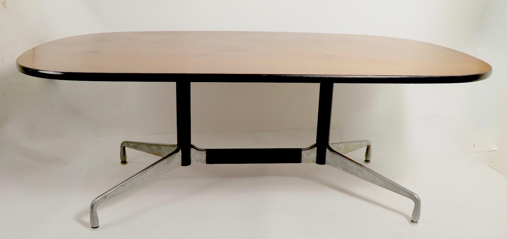 Classic Eames for Herman Miller conference table. Executed in the 1960s for the Aluminum Group series, this example has the desirable rosewood top. Originally designed as a conference table, it also functions well as a dining or work table. The