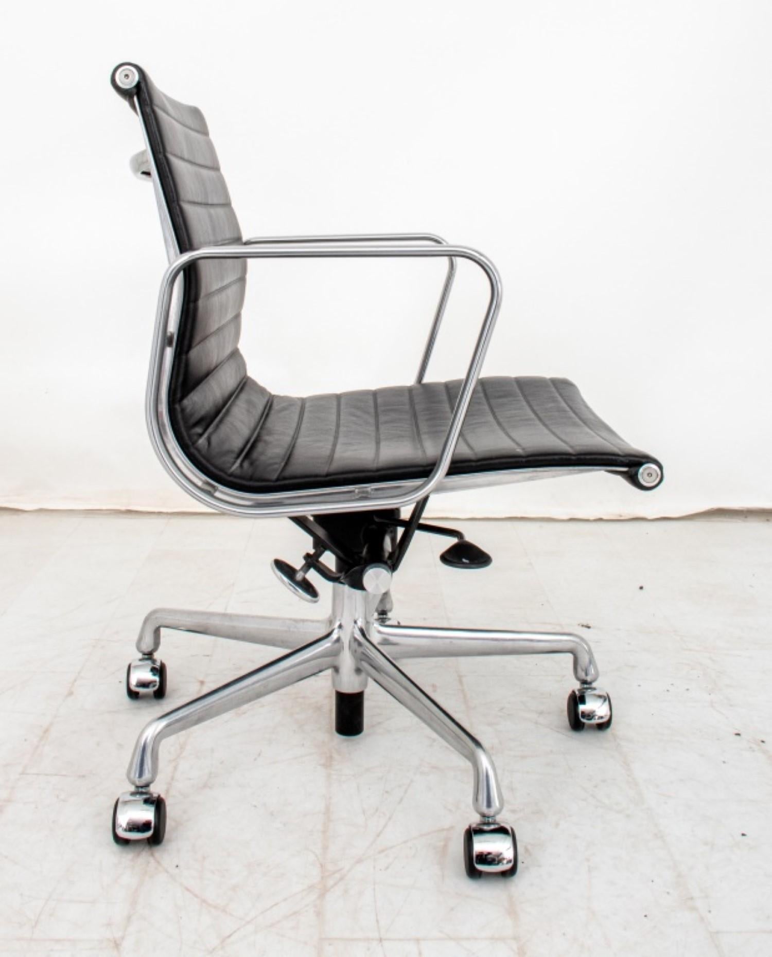 The Charles and Ray Eames for Herman Miller Chrome and Ribbed Vinyl Office Swivel Chair has overall dimensions of approximately 34.25 inches in height, 22.75 inches in width, and 21 inches in depth. This modern office chair is mounted on five