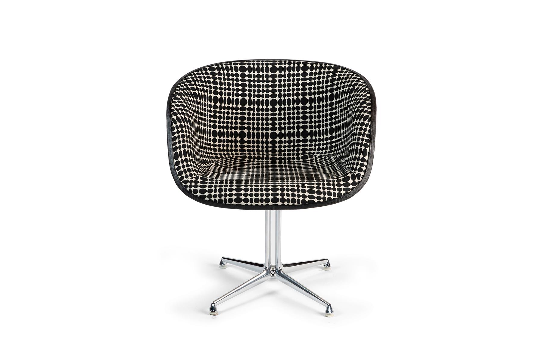 Pair of La Fonda chairs by Charles & Ray Eames for Herman Miller, circa late 1960s. These seldom seen examples have polished steel La Fonda bases and have been upholstered in a Op Art black & white dot Verner Panton for MAHARAM patterned fabric.