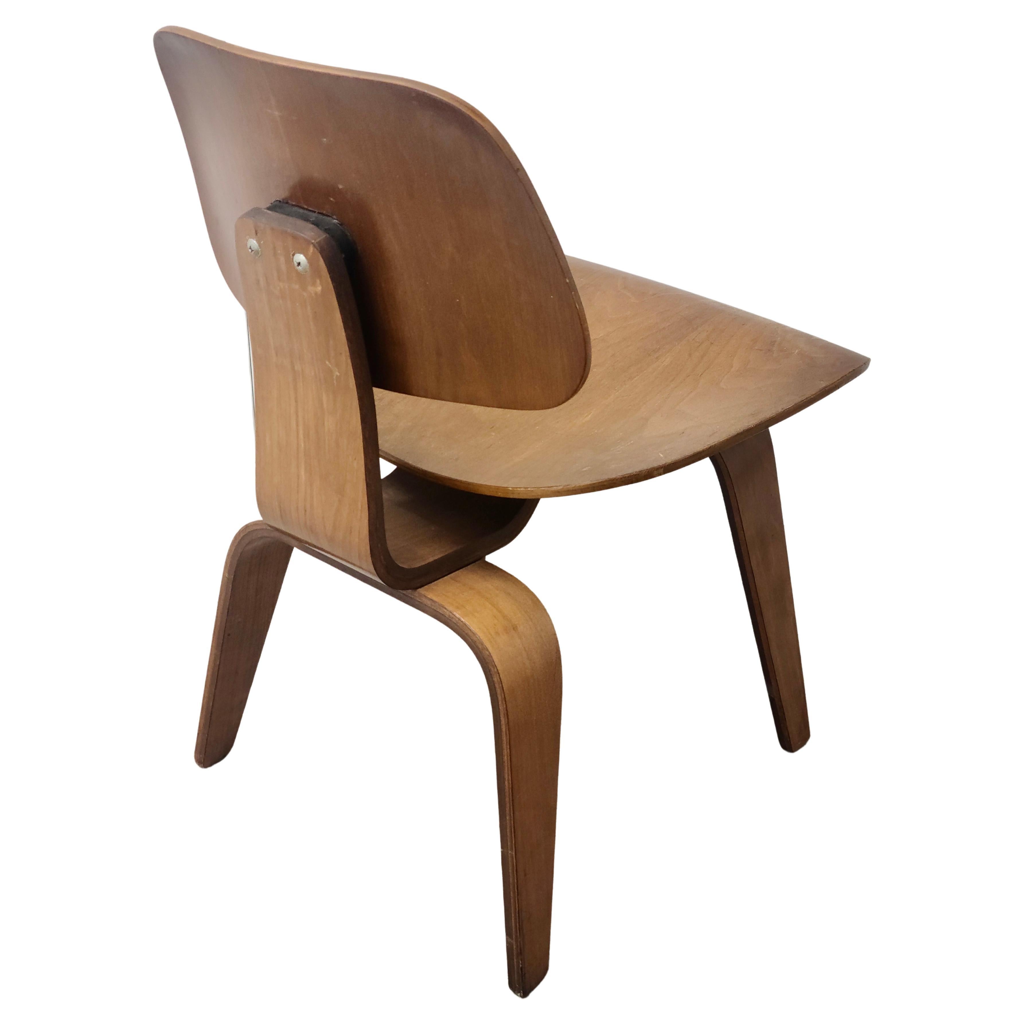 Please feel free to reach out for efficient shipping to your location.

Walnut Dining Chair Wood (DCW). Designed by Charles and Ray Eames
for the Molded Plywood Division of Evans Products. This chair manufactured
by Herman Miller. Note 5-2-4 screw
