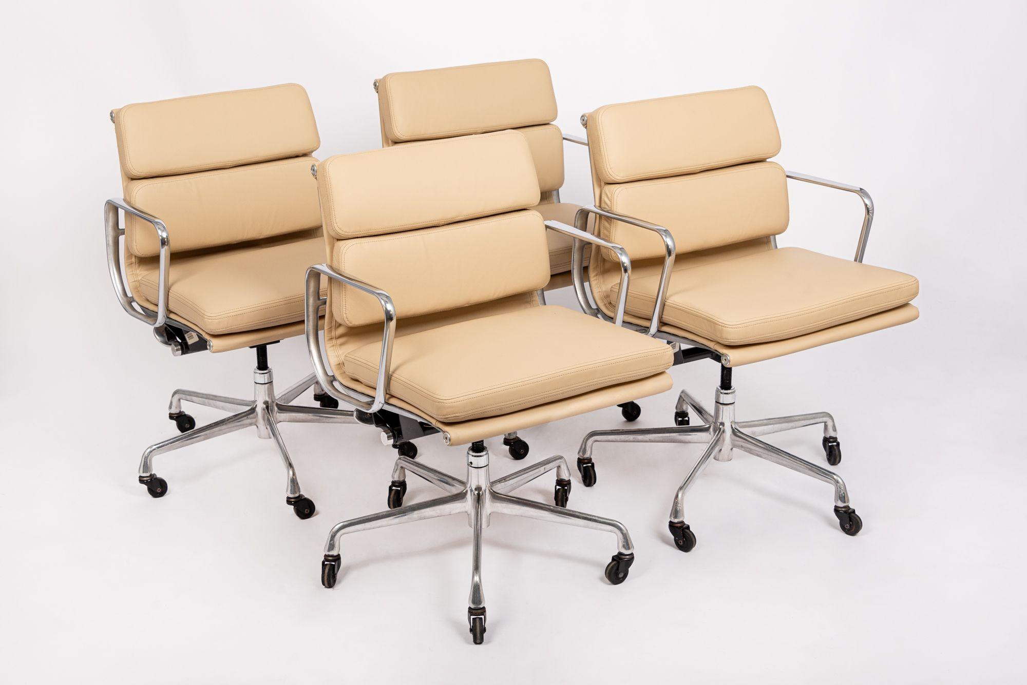 These authentic Eames for Herman Miller Soft Pad Management Height cream leather office chairs from the Aluminum Group Collection were manufactured in the 2000s. This classic mid century modern office chair was first introduced in 1969 by Charles