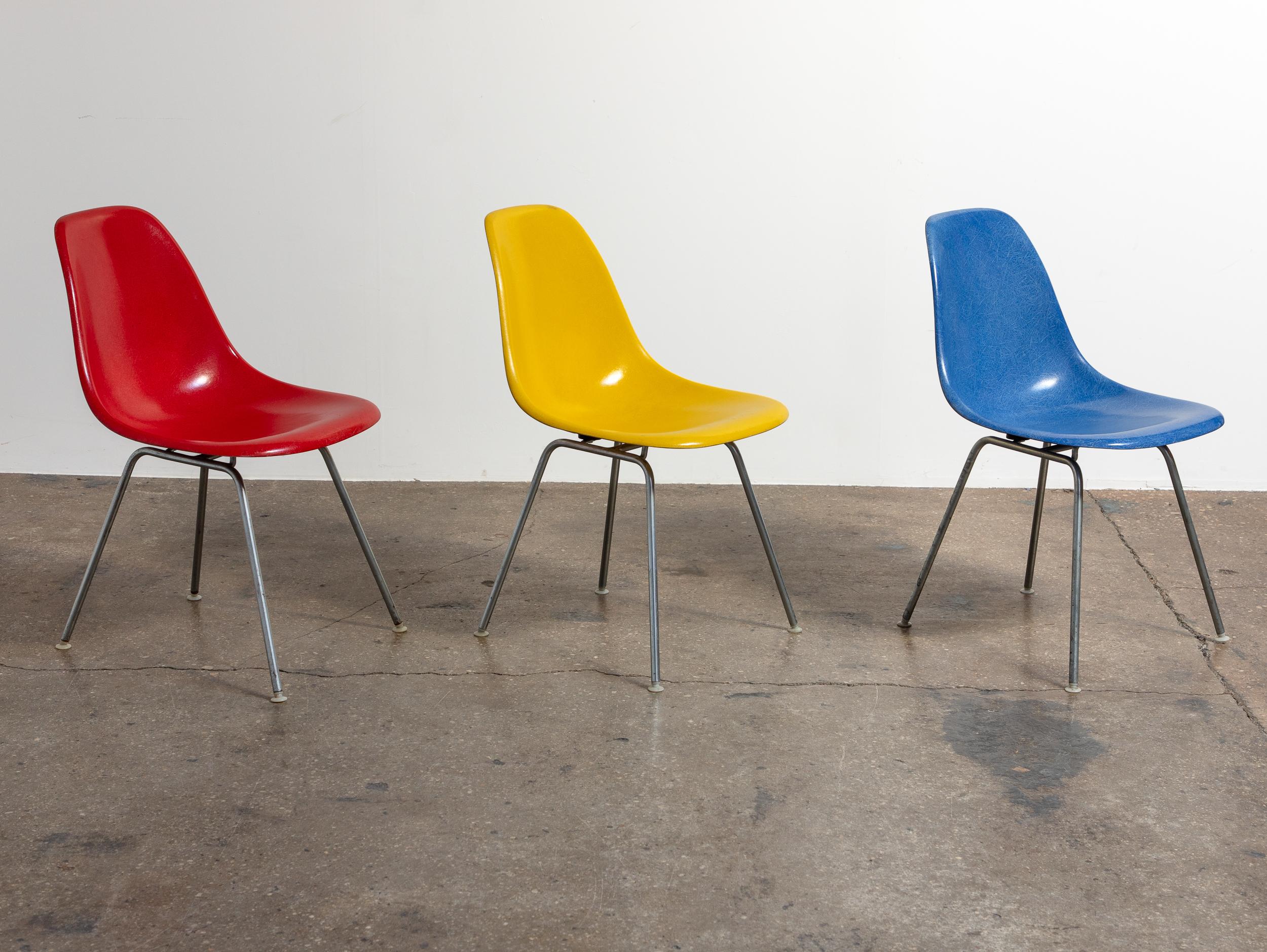 Multiple Available in Primary Colors. Original Molded Fiberglass Shell Chair, designed by Charles and Ray Eames for Herman Miller. Vintage shell chairs are prized for their attractive patina, distinct thread texture and beautiful depth of color seen