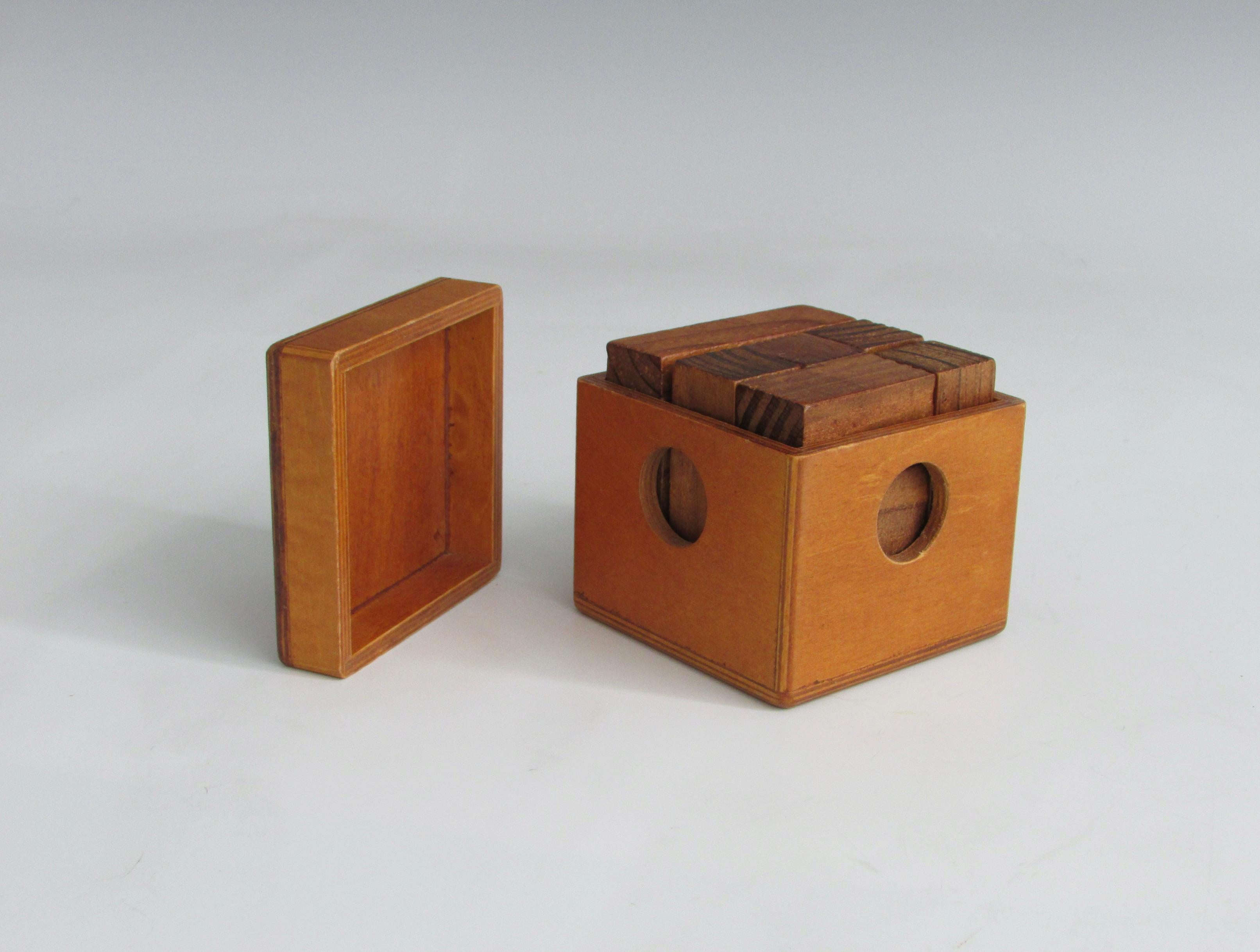 Geometric pieces of wood fitted together inside of laminate or plywood box.