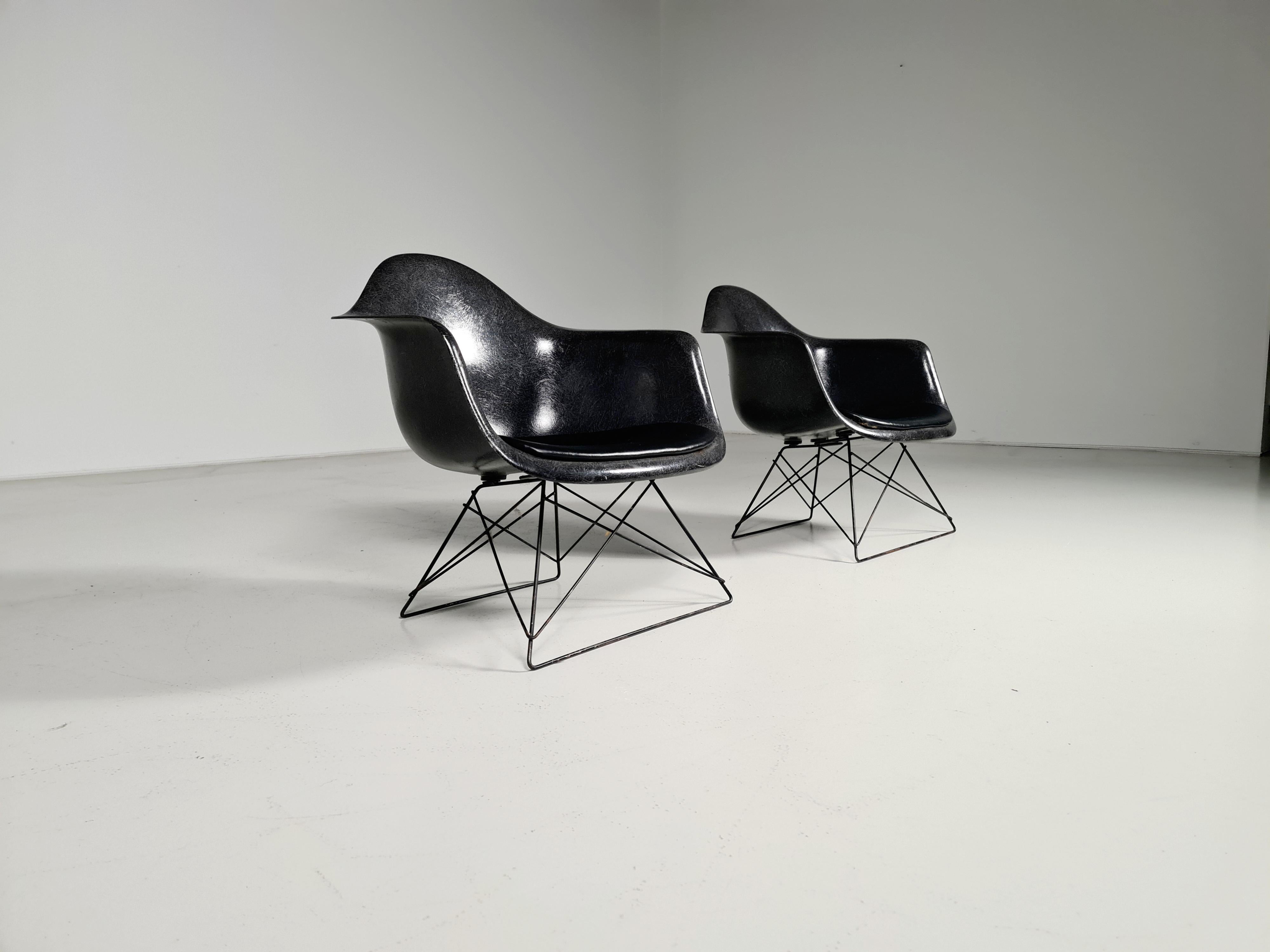 Charles and Ray Eames low armchair with cats cradle base (LAR). Made by Herman Miller. Fiberglass, black-plated and a black leather seat.

Signed with manufacturer’s mark to rubber underside.