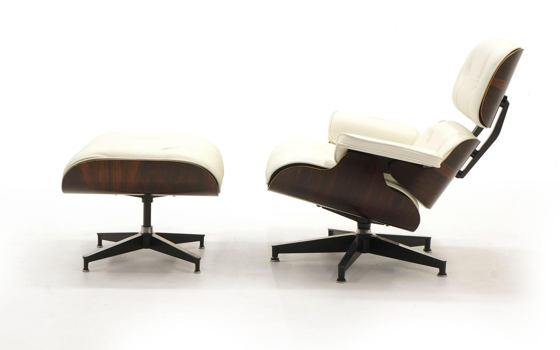 Charles and Ray Eames Brazilian rosewood Lounge chair with ottoman and new white leather cushions from Herman Miller. Signed with the early round white medallion. This set is the best of both worlds: rare, early production Brazilian rosewood and new